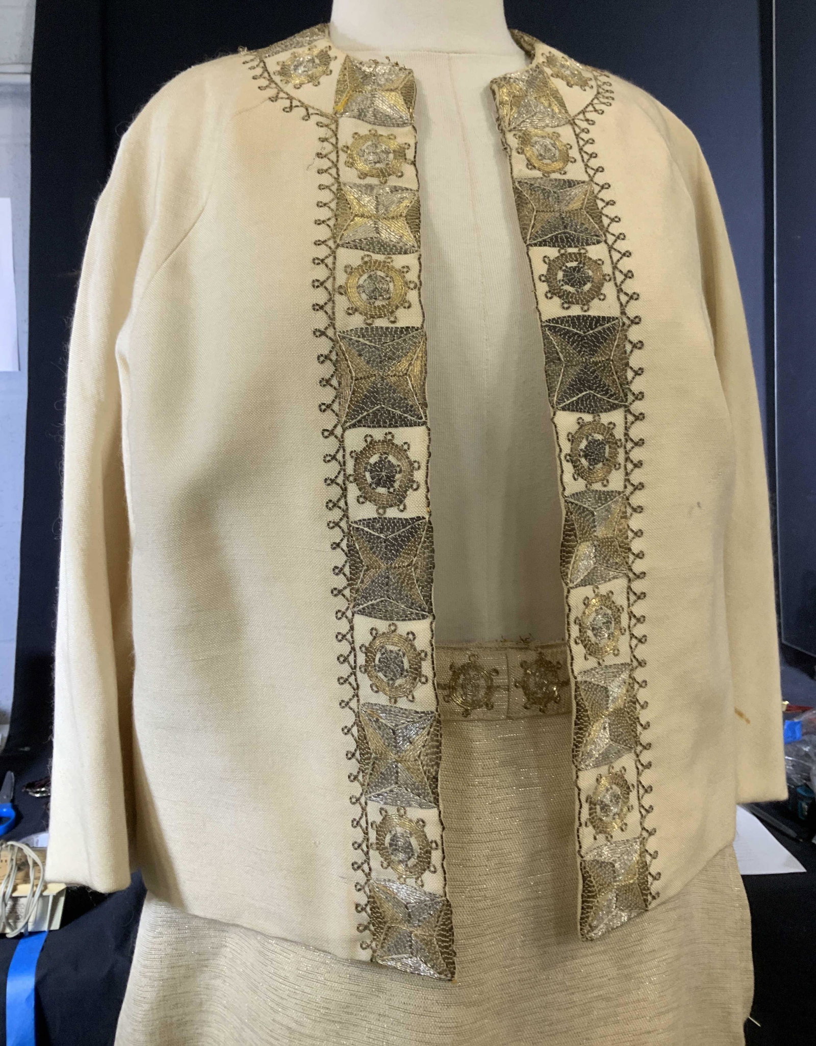 1960s Ladies Beaded Design Cocktail Skirt Suit: 26 in. Long metal thread skirt with side zipper, gold beading on hem, lined, small spot on backside, 30 in waist. Coordinating short jacket with similar silver and gold beading along collar, jacket in