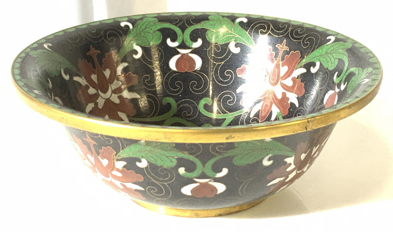 Vintage Chinese Cloisonné Trinket Bowl: Vintage Cloisonné bowl with light blue Enders ice enamel, and indication of Chinese Origin. Unmarked. Hand painted on brass, with brass accents. Flower motif . 5 in wide, 2 in ht. Asian trinket bowl,