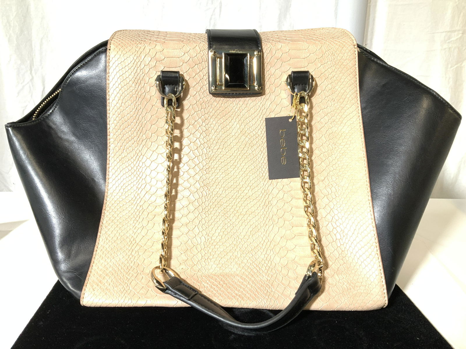 BEBE Snakeskin Style Chain Lrg Hand Bag, Org tag: Stylish Handbag by Bebe, with Curd chain gold tone handles, drop 8 in. Clasp is a large beveled crystal that twists. Faux tan snakeskin offsets black faux leather sides. Comes with original tag, clean