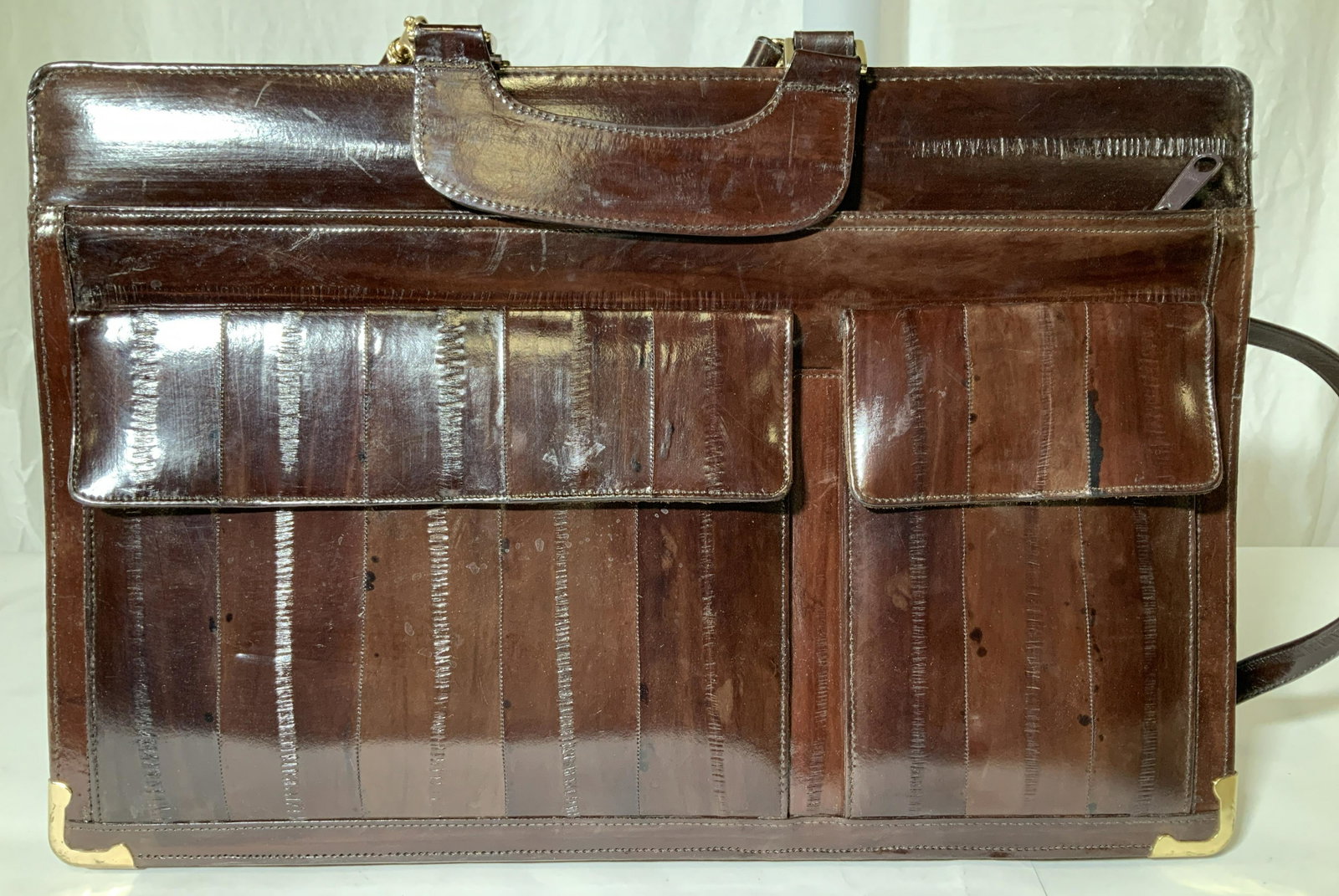 Brown EEL SKIN Messenger Shoulder Briefcase: Luxury Eel skin Briefcase/ Shoulder Messenger Bag with Reinforced mental corner hardware, , carry handle and Detachable strap, 18 in. drop. Front snap pockets, dual side zipper paper compartment, sued