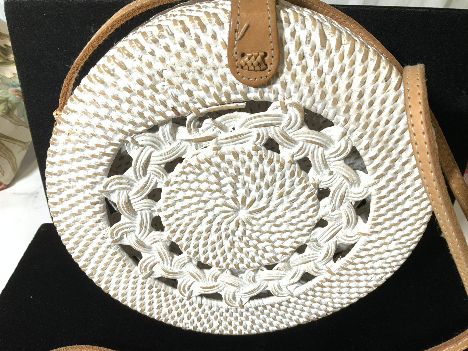 Pierced Woven Basket Cross Body Bag: Accessorized with Long leather strap and snap closure, this purse is made of solid straw with a white wash. 8 in. Diameter , 3.25 in depth, opens on a hinge. Property of Palm Beach Estate. Cross body 