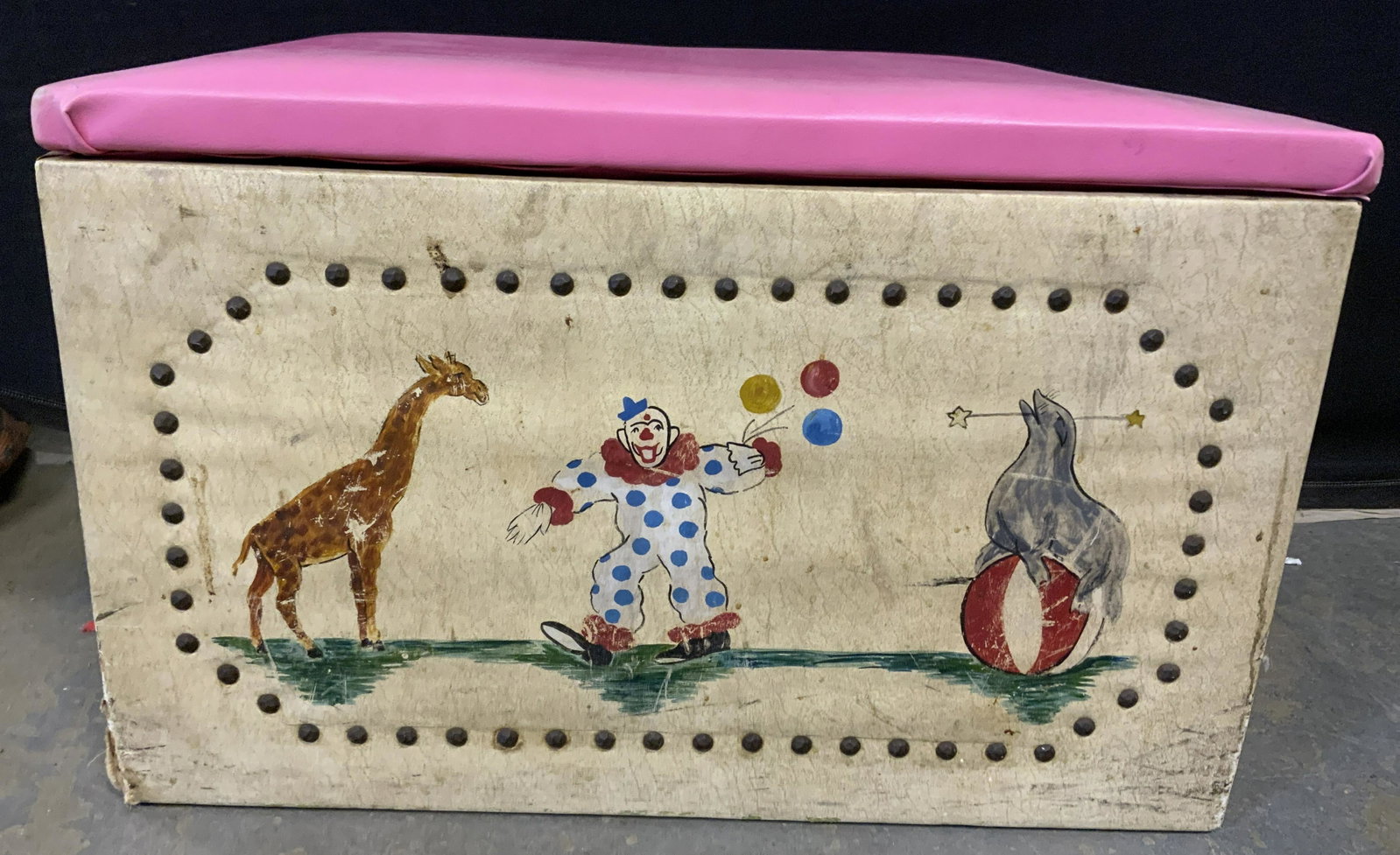 Vintage Leather Trunk w Circus Artwork: Vintage leather trunk. Illustration on front is hand painted, depicts a giraffe, clown, and seal. Leather is secured to trunk with brass nails, leather on lid is secured through the use of staples, li