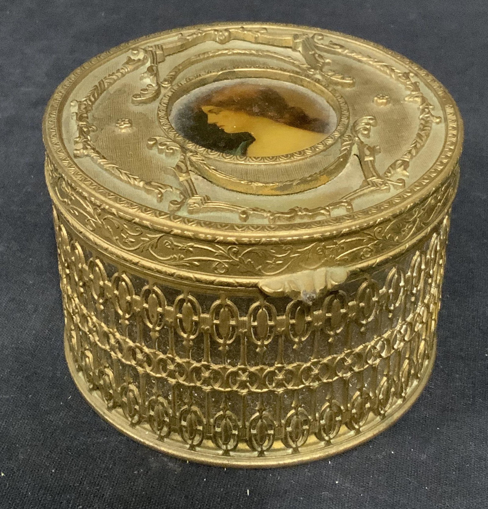 Vintage Gilded Metal & Glass Vessel: Vintage, possibly antique, gilded metal and glass vessel. A portrait of a woman sits at the center of the lid, body is gallery style and houses a glass cup. Measures approx 2.5 inches H and 3.5 inches