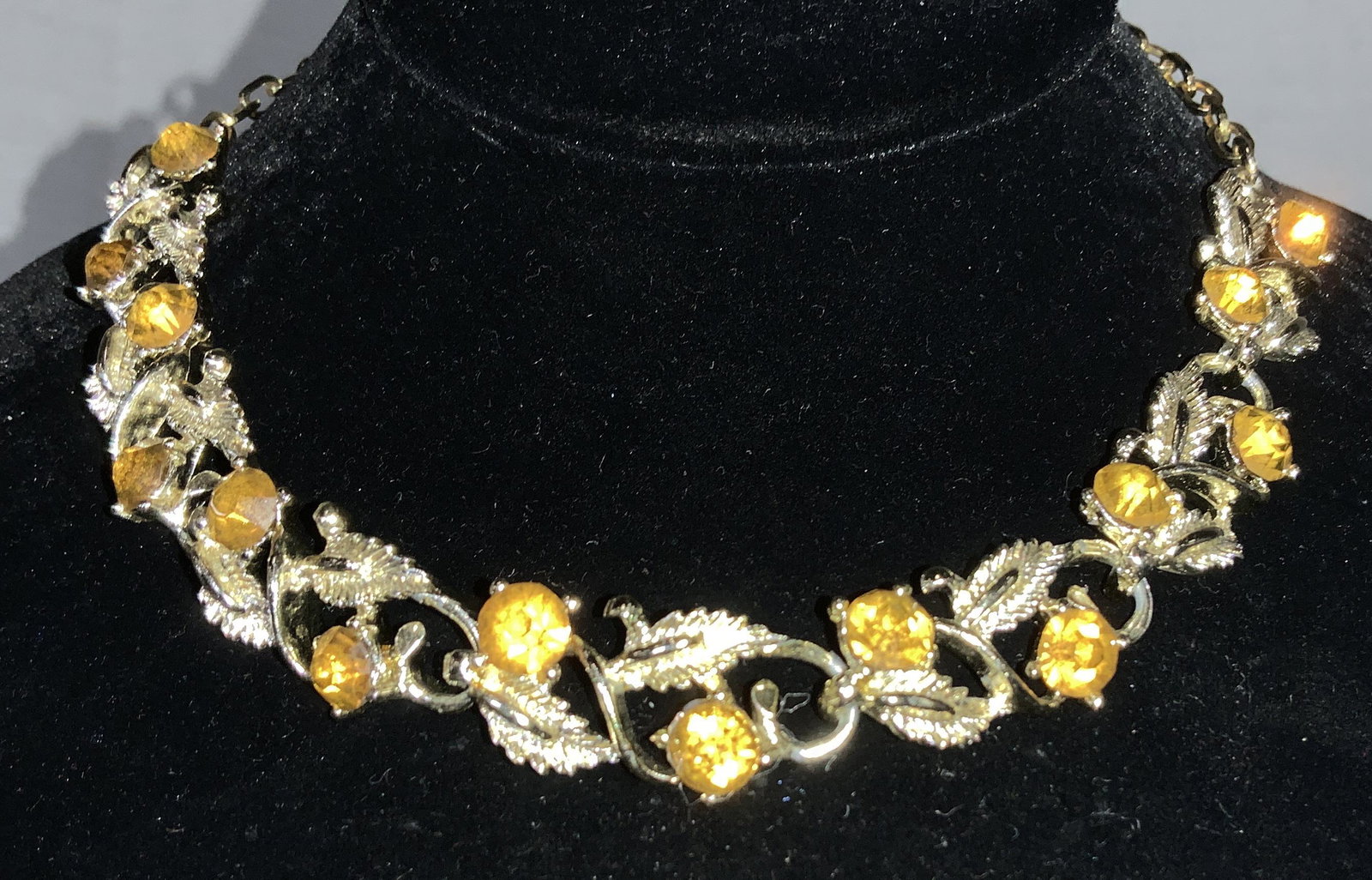 Mid Century Orange Rhinestone Choker Necklace: 11.5 - 15.5 in. Necklace has a rich color and art nouveau pattern of etched leaf links with brilliant orange rhinestones, app 7 mm rounds. Metal in good condition. Art Nouveau Style Choker Necklace, R