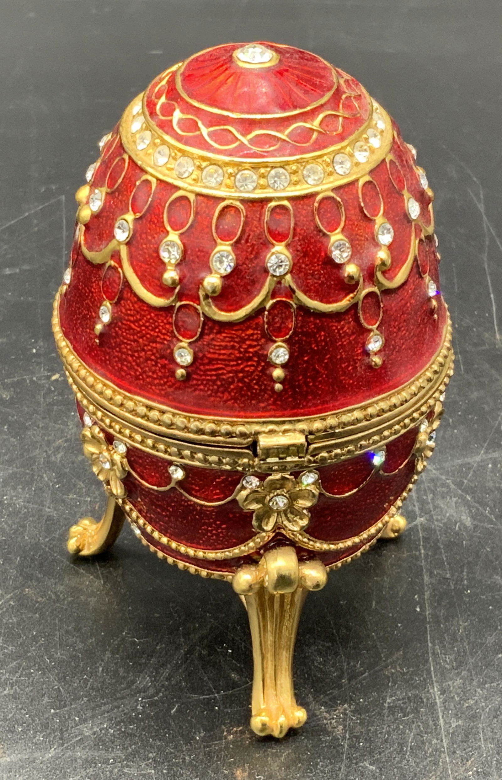 Faberge Egg Trinket Music Box: Faberge egg trinket music box, label to interior reads ‘Lex in the city September 10, 2005’, egg does not close all the way, key to wind up music box located inside, interior lined with red felted