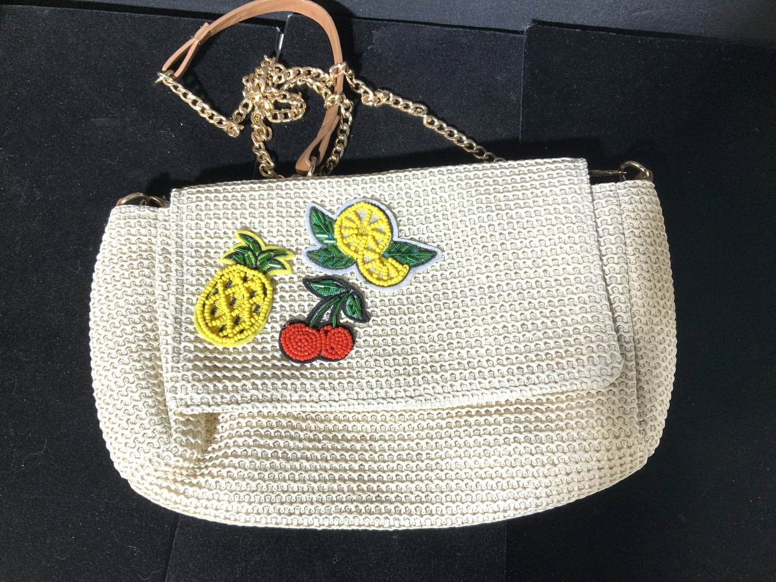 Ladies Beaded Fashion Purse with Chain Strap: Beaded Pineapple, Cherry, and Lemmon decor on front flap, snap closure, zippered side interior pocket. Poly lined fabric. Works as a clutch or shoulder bag, gold tone curd chain with leather style sho