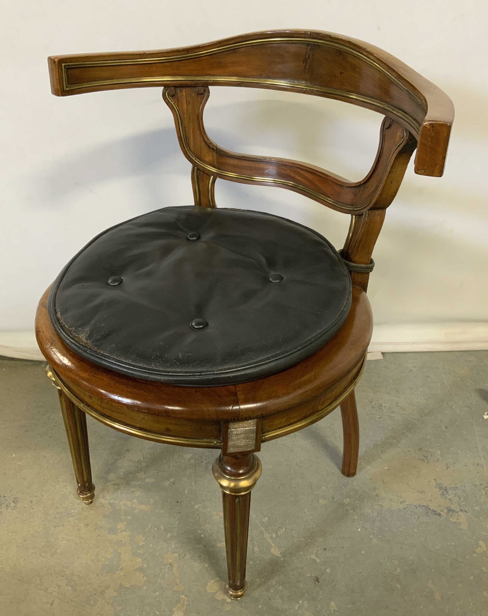 Vintage Wooden Library Chair w Cushion: Vintage wooden library chair, possibly antique. Crafted from wood, decorated with inlaid brass detailing, front legs are fluted, charge appears to be cane. Measures approx 31 inches H and 24.25 inches