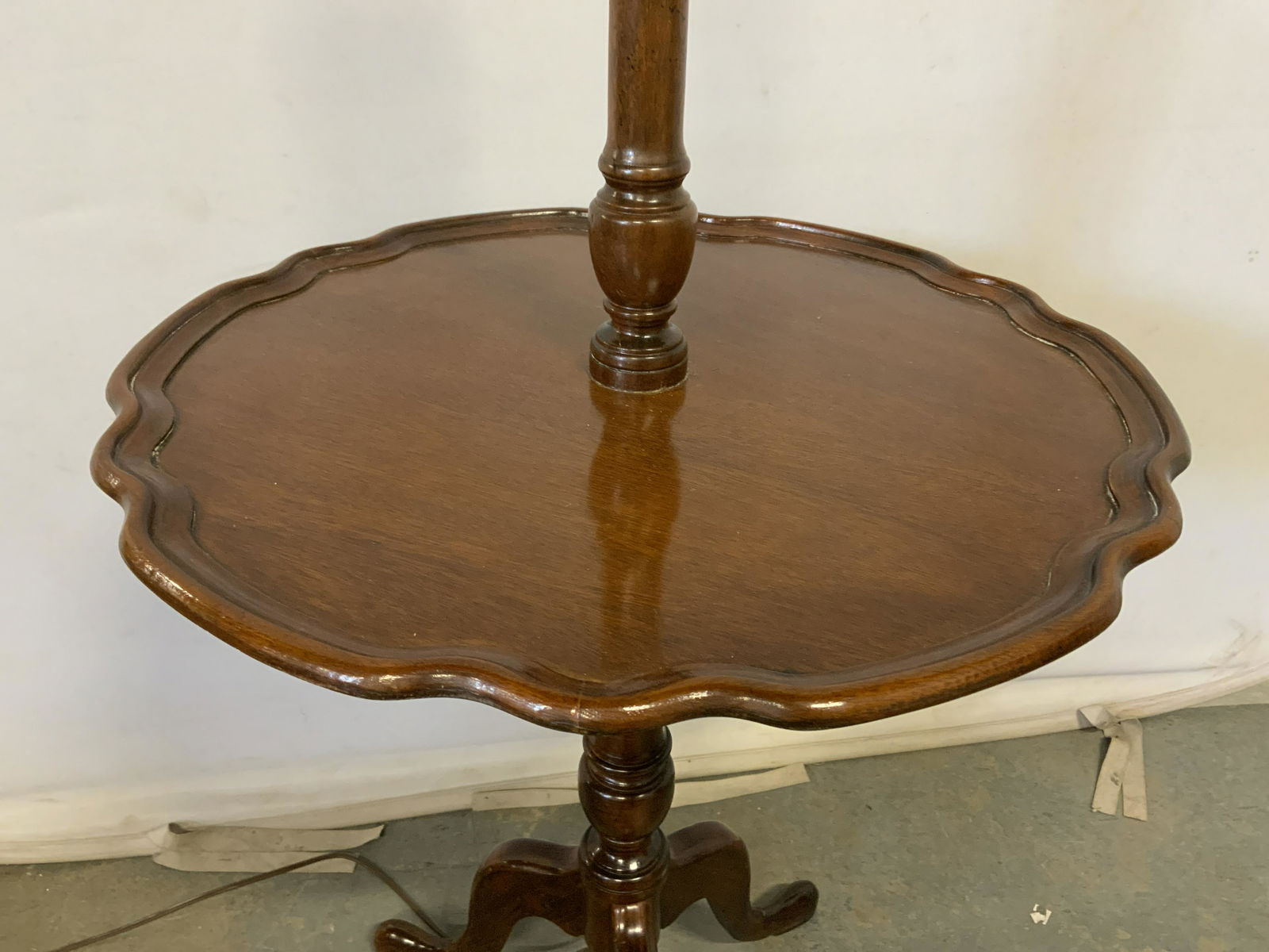 Carved Wood Pie Crust Table Lamp: Vintage pie crust table lamp, appears to be mahogany. Lamp is affixed to the table. Measures approx 65 inches H, and 23 inches in diameter. Functionality has not been tested. Wear is consistent with a