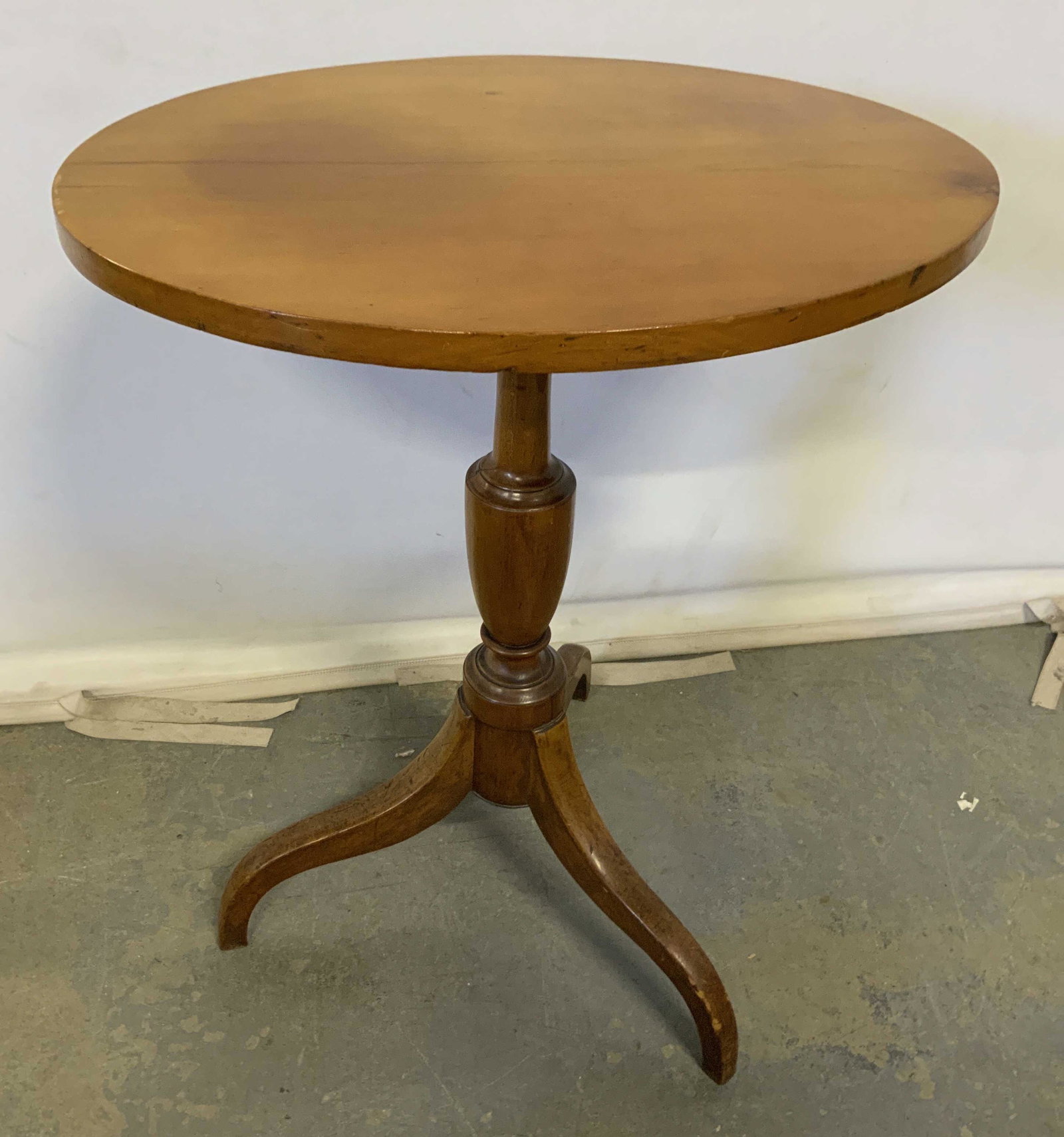 Vintage Wooden Side Table: Vintage wooden table. Oval tabletop, column sits on three legs. Measures approx 27.5 inches H and 22 inches W. Wear is consistent with age and use. Wooden table, side table, end table, occasional tabl