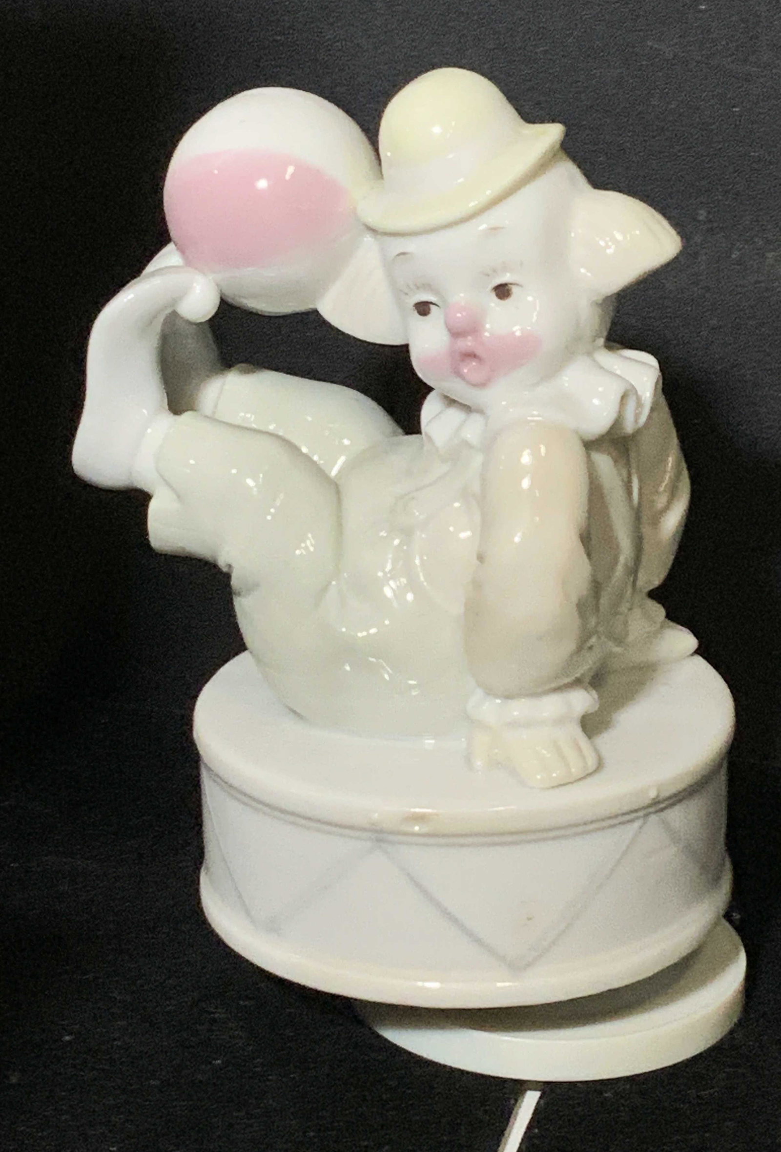 Porcelain Clown Rotating Music Box, Org Box: Apex Quality Porcelain clown holding ball with feet. Twist bottom for music to play and clown figural rotates. Comes in original box. Made in Taiwan. 6.5 in tall, 5 in wide. Music Box, Porcelain clown