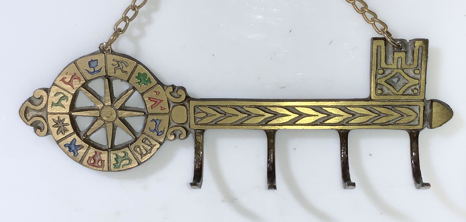Astrology Symbol Brass Key Chain Holder, Israel: Vintage Brass key chain holder or other hanger for lighter weighted objects, depicts the astrological symbol for each sun sign, 4 hooks, chain. 6.25 in long, 2 in ht, chain drop with object 4 in. Boug