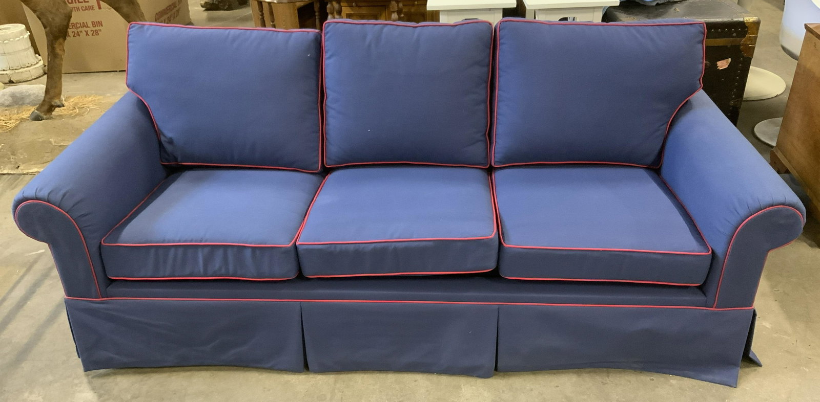 Sofa w Pull Out Mattress: Navy blue sofa with red welting. Pull out mattress housed within. Measures approx . Wear is consistent with age and use. Two legs need to be reattached. Sofa, love seat, bed, mattress, living room fur