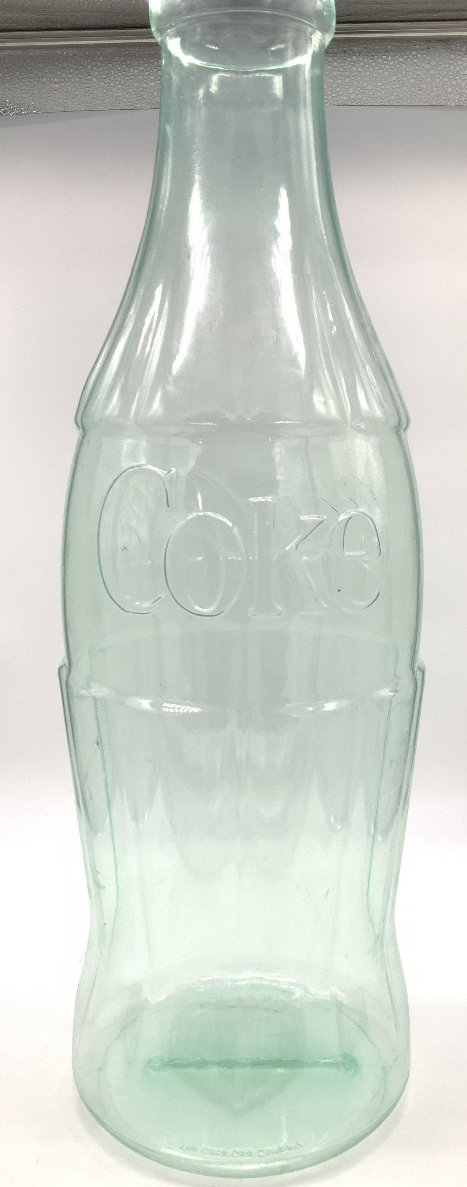 Grand FL Size Coca Cola Collectible Bank: Vintage Clear Plastic Bottle Coca Cola Bank, 22.5 in tall, 7 in width. Shaped into the vintage classic Coke glass Bottle, pull off cap with coin slit. Manufactured by The Flexcraft Co. novelty Bank, F