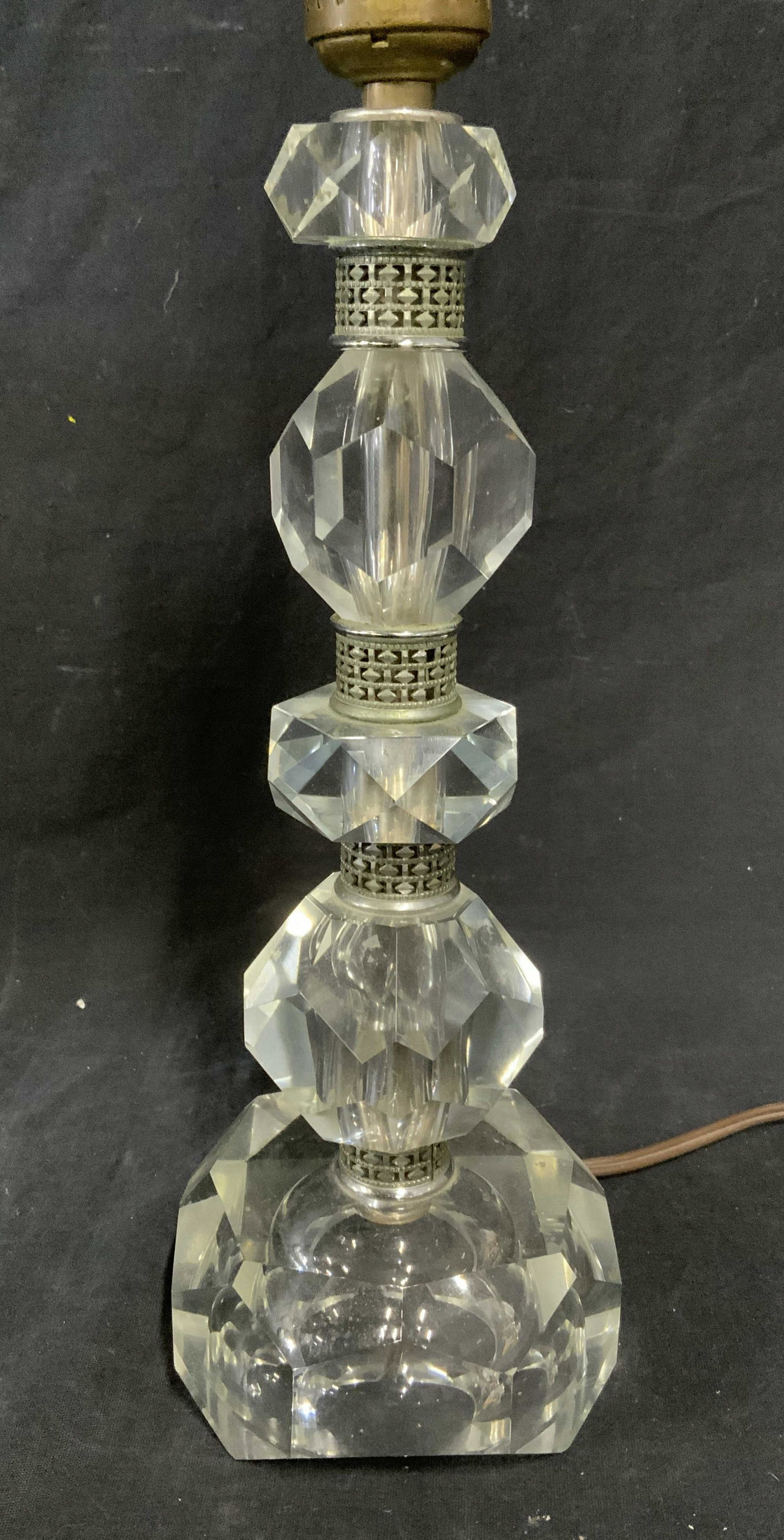 Vintage Cut Glass Tabletop Lamp: Vintage tabletop lamp. Pierced metal rings separate glass sections. Measures approx 17.75 inches H, and 8 inches W. Wear is consistent with age and use. Lamps, lighting, vintage lighting, vintage deco