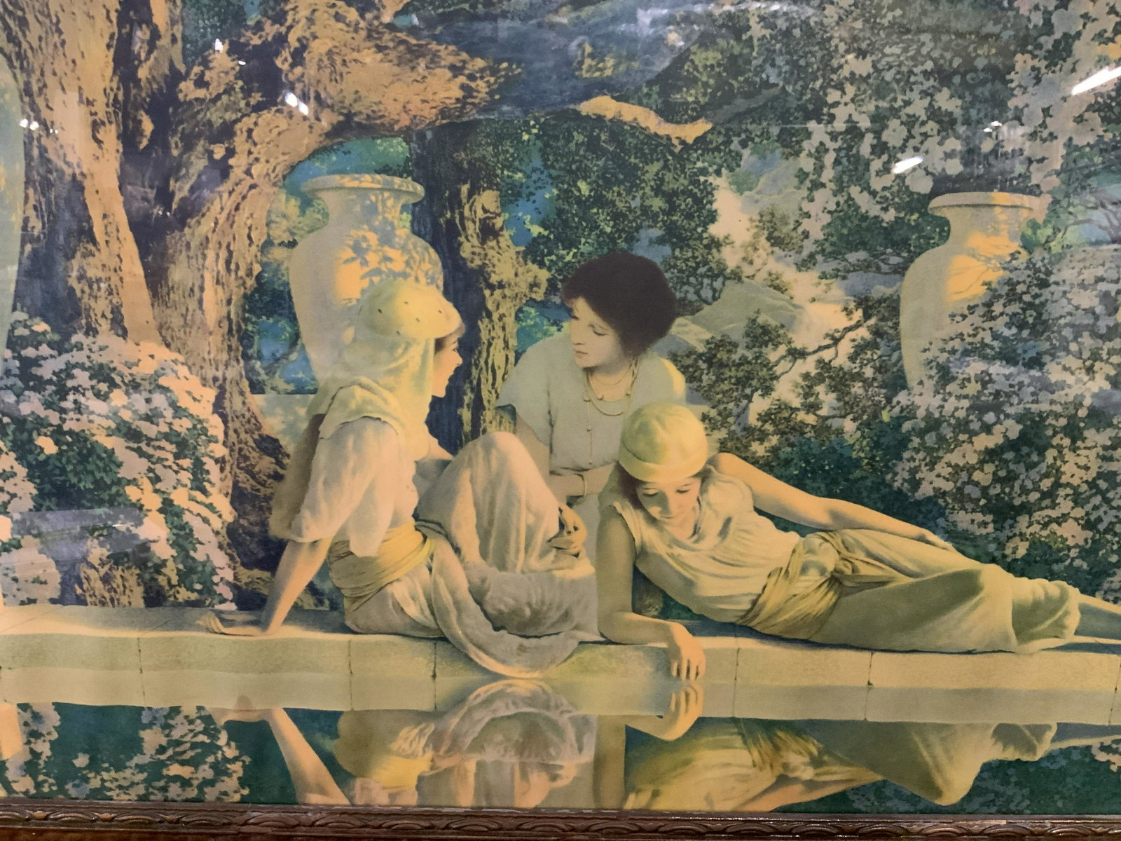 M.Parrish Offset Litho The Garden of Allah: Maxfield Parrish’s The garden of Allah offset lithograph, initials to the lower right corner read ‘M.P’, subject three women lounging about a garden with flowers and large vases about them, wood