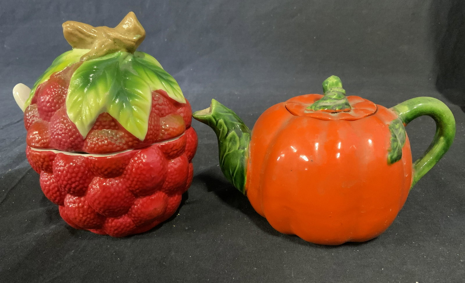 Lot 2 Ceramic Sugar Bowl & Tea Pot: Lot includes a kettle and sugar bowl. The sugar bowl resembles raspberries, the kettle a pumpkin. The pumpkin is trademarked, the manufacturer name is illegible, the rest reads as HAND PAINTED JAPAN. 