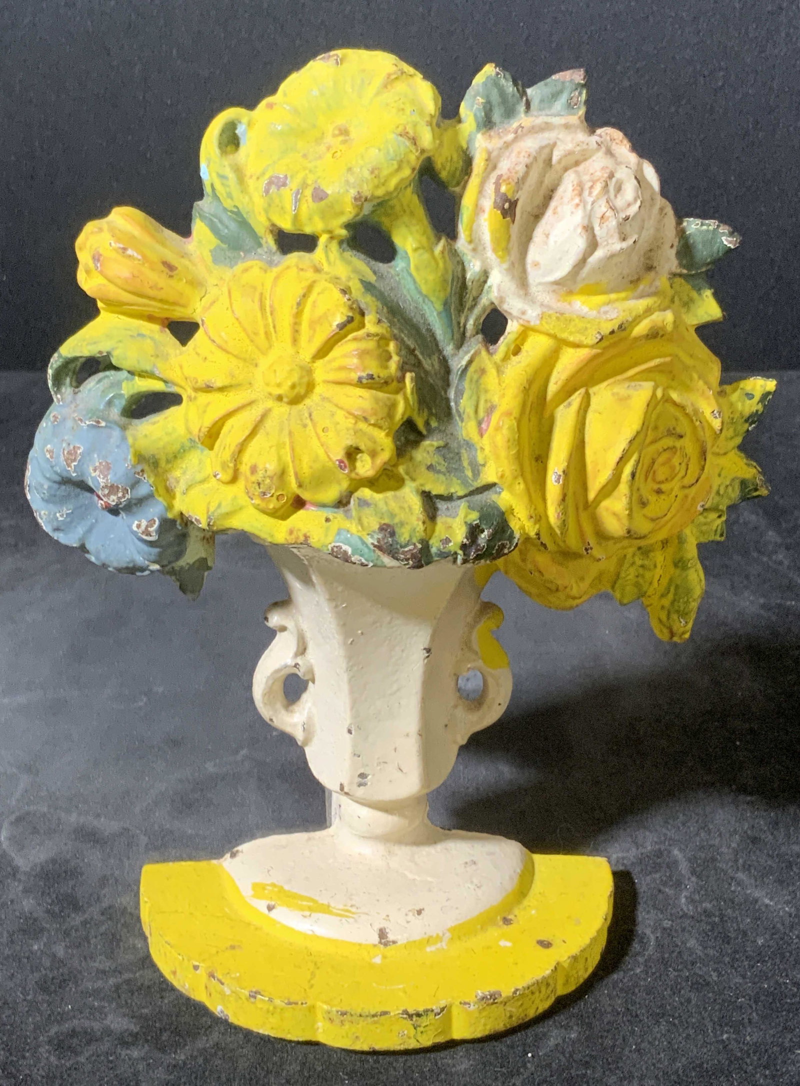 Vintage HUBLEY Signed Iron Floral Form Doorstop: Vintage hand painted doorstop crafted from metal, possibly iron, and molded to resemble the form of flowers in a vase. Primarily white, yellow, green, and blue hues. Reverse is white. Reverse reads HU