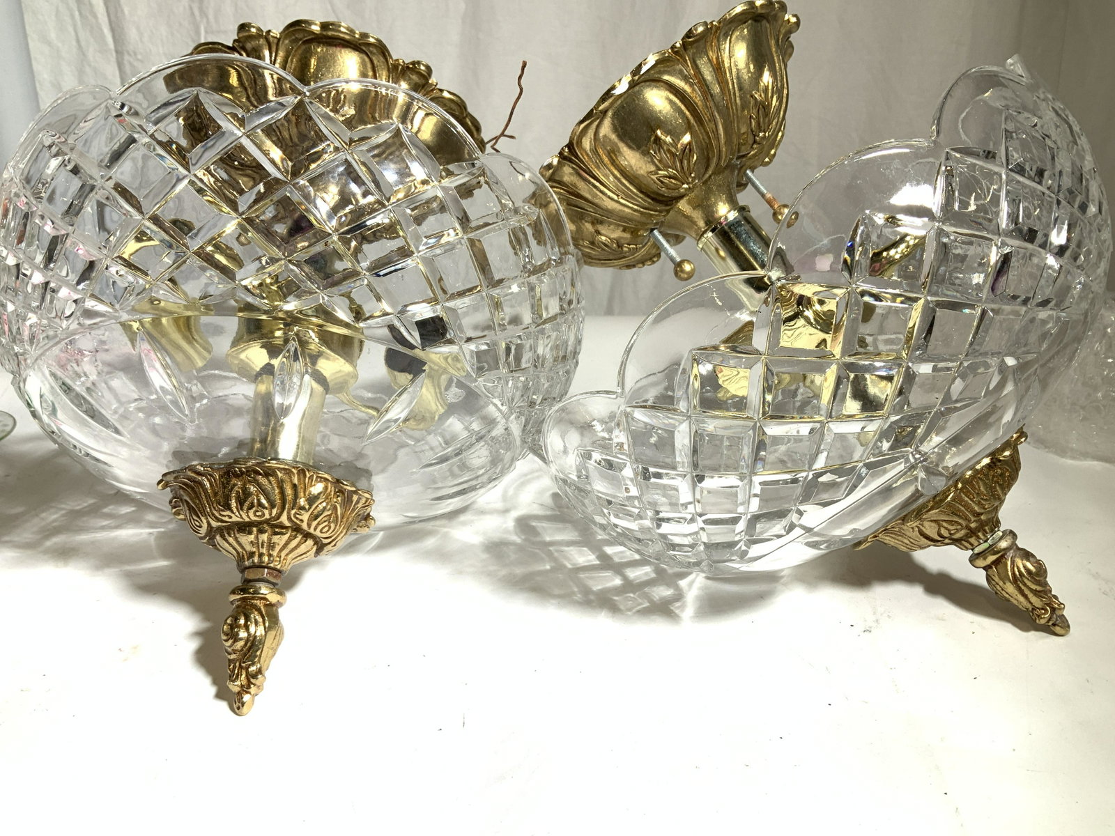 Pair Brass & Crystal Ceiling Lamps, Slovakia: Molded Cut Crystal Ceiling lights with brass toned finial and flush Mount ceiling plate in relief, scalloped rimmed edge, sticker label on crystal reads made in Slovakia, lead crystal, 24% PBO, screws