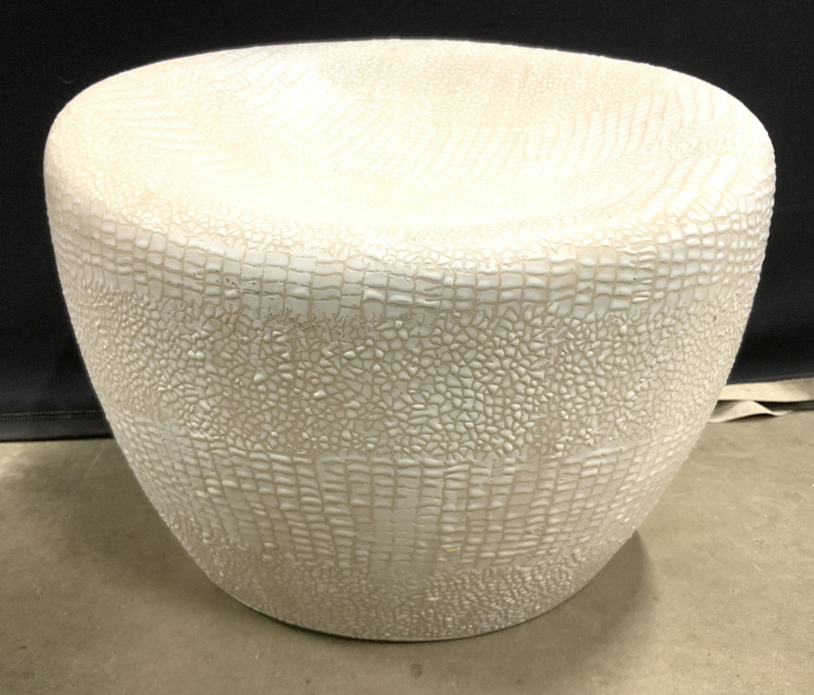 Cream Toned Low Porcelain Garden Stool: Stool is cream toned & porcelain. Piece has textured detail. Stool measures approx 15 inches tall 19 inches wide. Stool, porcelain stool, garden stool, porcelain garden stool. contemporary design, 6