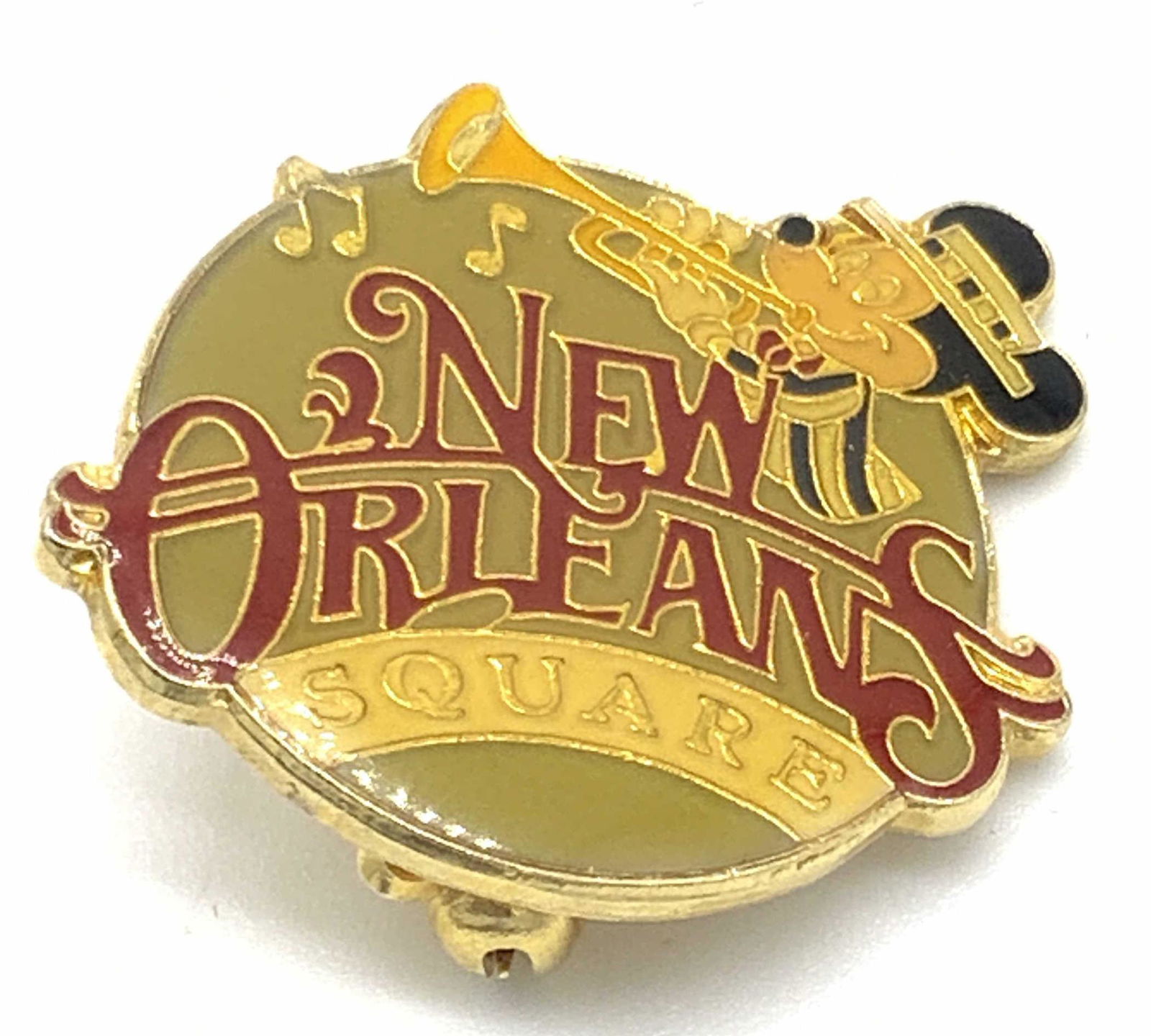 Vntg WALT DISNEY PRODUCTIONS Mickey Mouse Pin: Vintage gold tone metal and enamel pin featuring the image of Mickey Mouse playing a trumpet. The obverse reads NEW ORLEANS SQUARE. Reverse reads WALT DISNEY PRODUCTIONS, TAIWAN. Reverse secures with