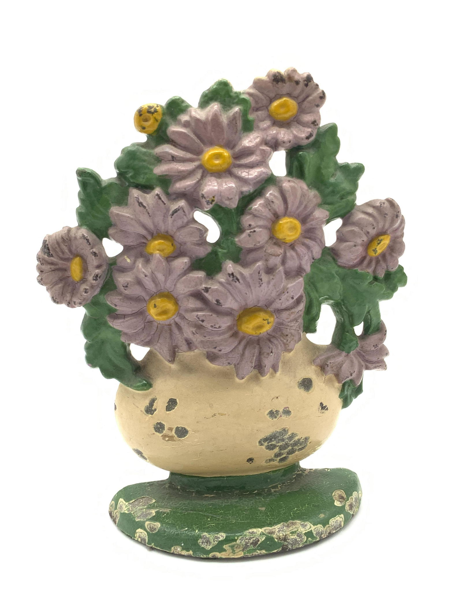 Vintage Floral Form Iron Doorstop: Vintage hand painted doorstop crafted from metal, possibly iron, and molded to resemble the form of flowers in a vase. Primarily white, yellow, green, and purple hues. Reverse is purple hued. Approx.