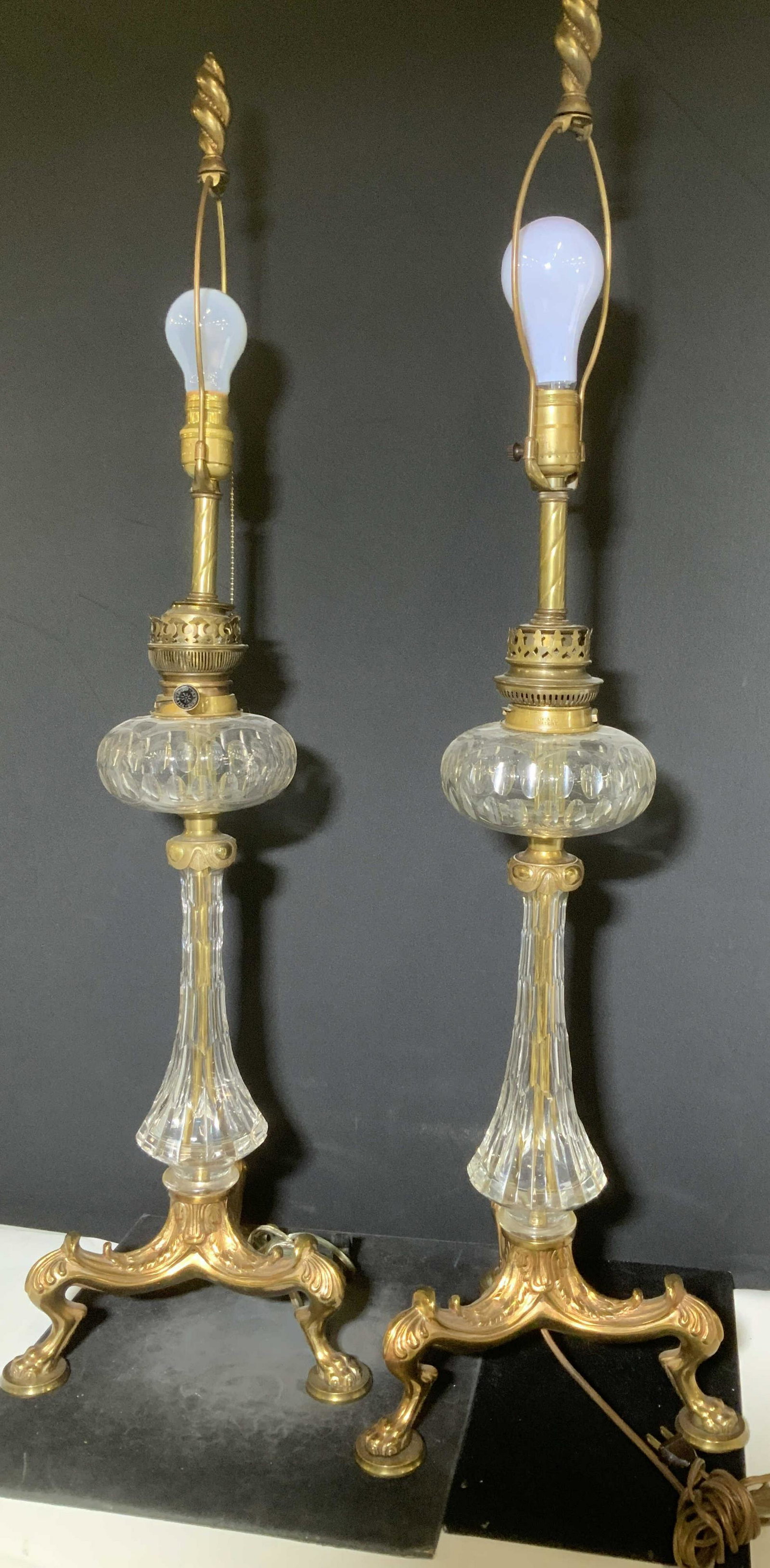 Pair Tall Claw Foot Gilt Bronze & Crystal Lamps,: Vintage lamps with a regal Baroque style, three footed claw foot base of gilt bronze with cut crystal body, balloon orb appears to be cut glass, possibly originally an oil lamp converted into a pull c