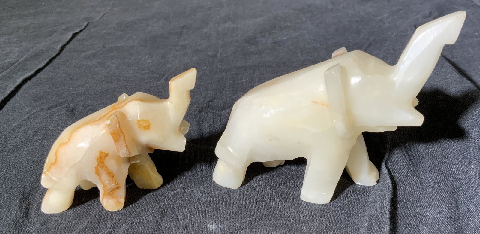 Lot 2 Natural Cut Stone Elephant Figurals: Lot 2 natural cut stone elephant figurals, no apparent inscriptions or markings, subject two brown and white stone elephants one larger than the other mid stride, larger of the two measures 3 inches t