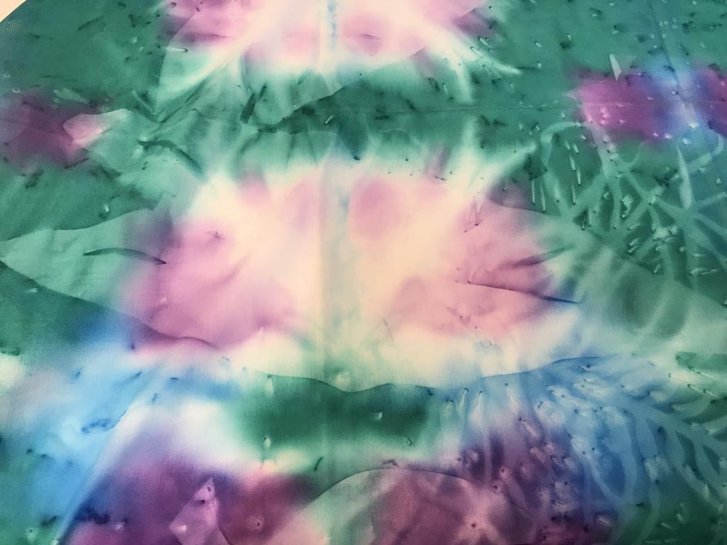 Tie Dye Cotton Batik Style Fabric, Multi Uses: Batik/ Tie dye Style Aqua Green and Blue with purple and hints of white. Soft fern patterns and large leaf patterns that are not too defined and blurred with color. 44 x 70 in. app / 1+ yard wide, 2 y