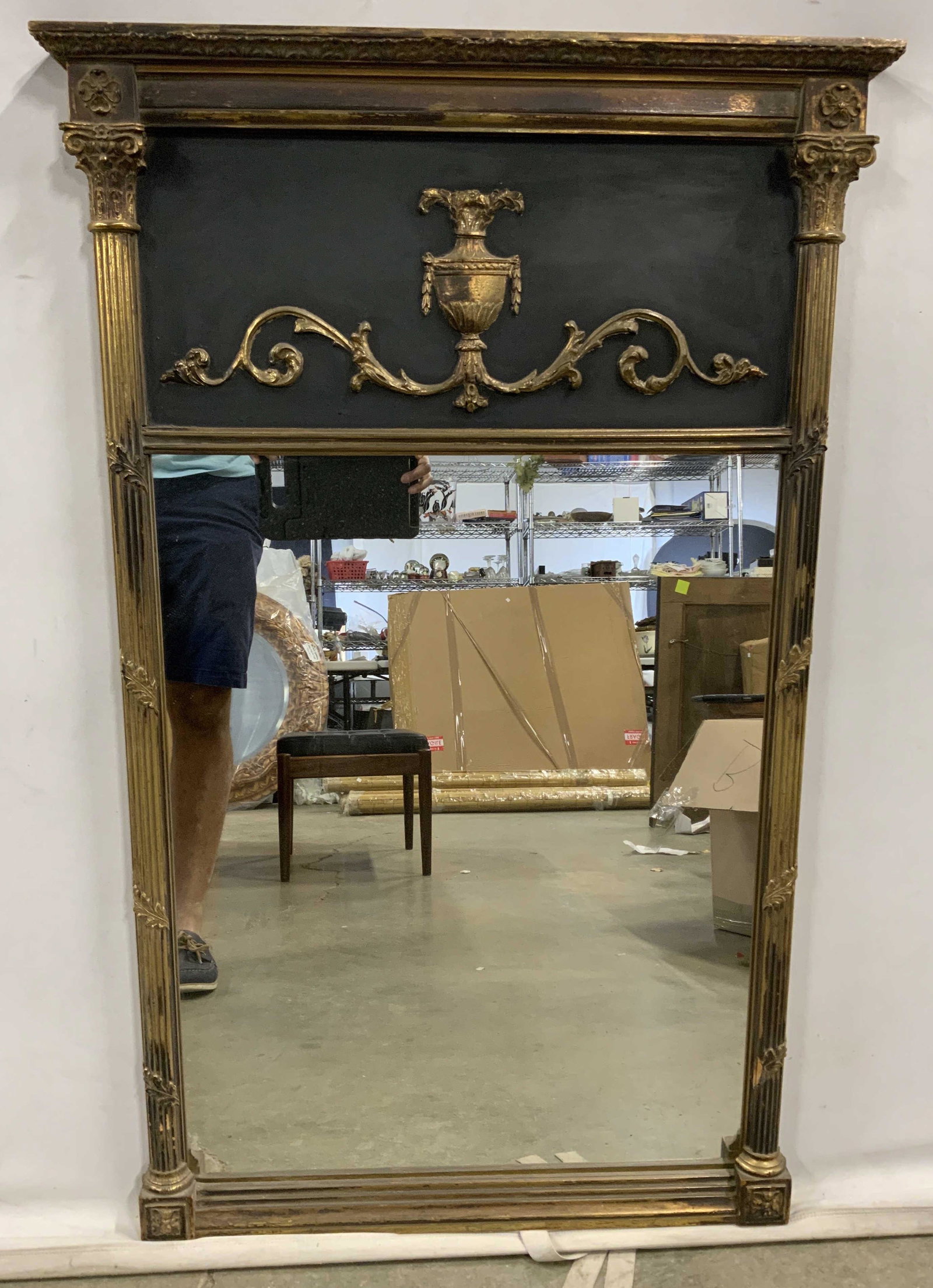Vintage Ornate Victorian Style Mirror: Mirror is vintage possibly antique. Piece is black and gold toned with ornately detailed upper area with beveled urn detail. Piece measures approx 42 inches tall 26 inches wide. Mirror, vintage mirror