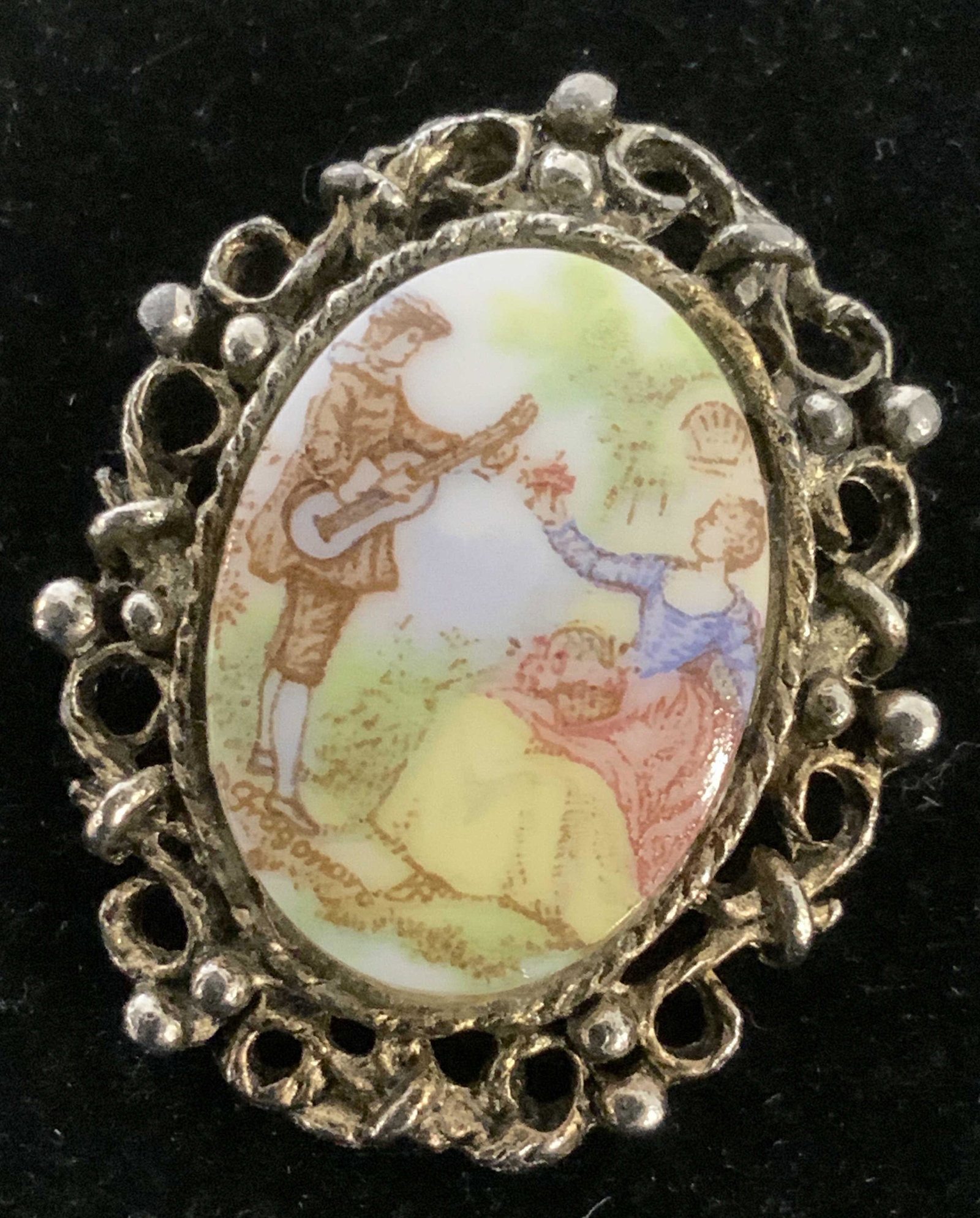 Vntg French FRAGONARO Rococo Brooch, Signed: Oval ceramic brooch transfer ware depicts 18th c. courting couple. Encased in a muted brass toned metal, a luxurious mix of French Style Rococo filigree and artwork. Brooch is signed by French Artist 