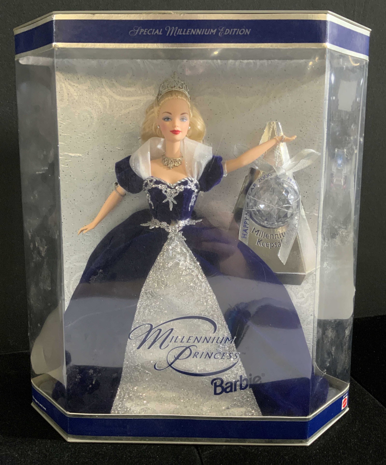 Collectible MILLENNIUM PRINCESS BARBIE W/ Box: A collectible Millennium Princess Barbie doll with her Millennium Keepsake 2000 Ball. She wears a deep blue gown with lustrous silver hued accents. She is in her original box. Likely never used or ope
