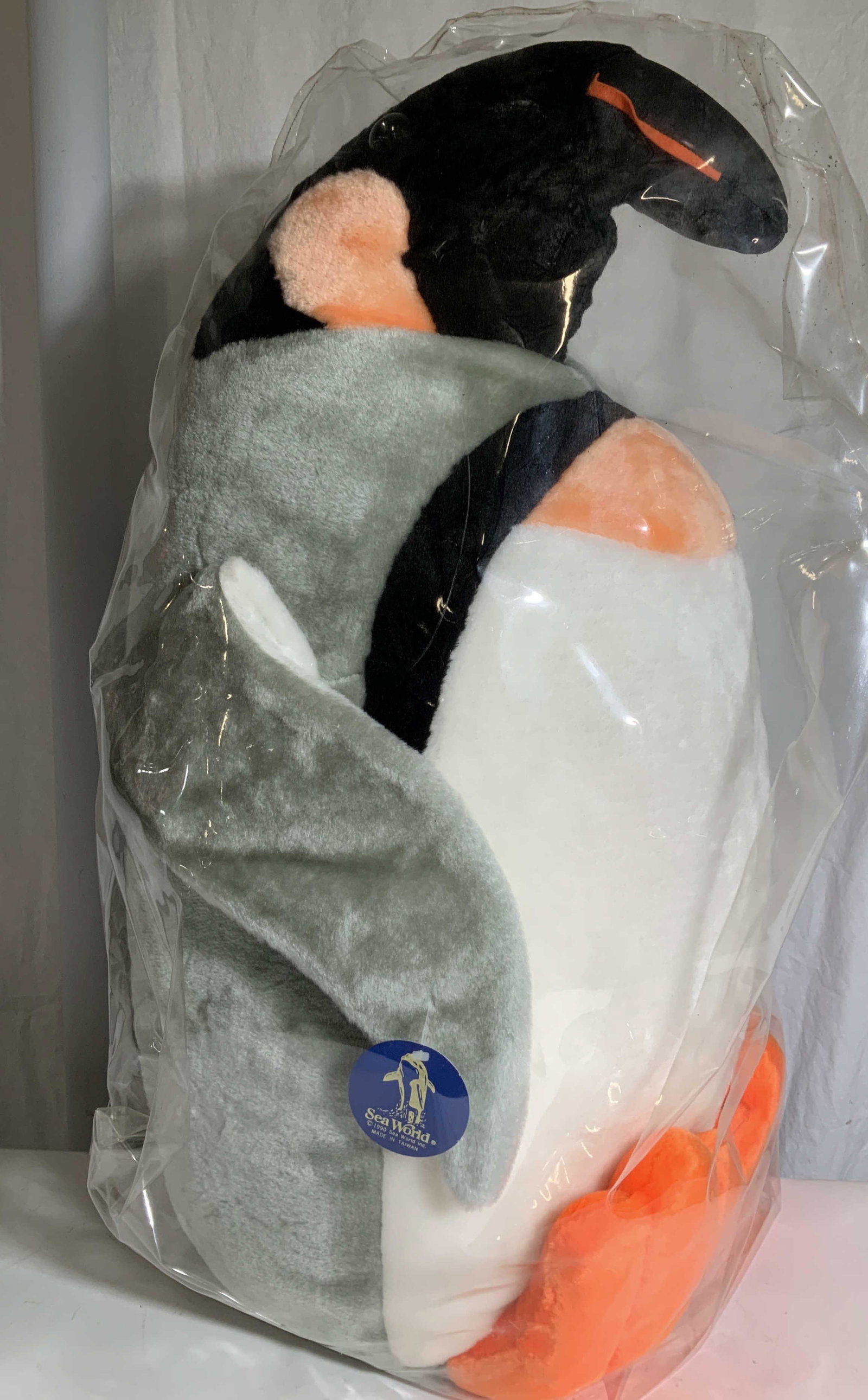 Floor Size Penguin Suffed Animal, Sea Word: Vintage 1990 Sea World Children’s Stuuffed Toy- Life Size Penguin with bright orange webbed feet, white belly, grey body and wings, ORIGINAL Tag Attached to items. In thick plastic bag. 29 in ht, 15