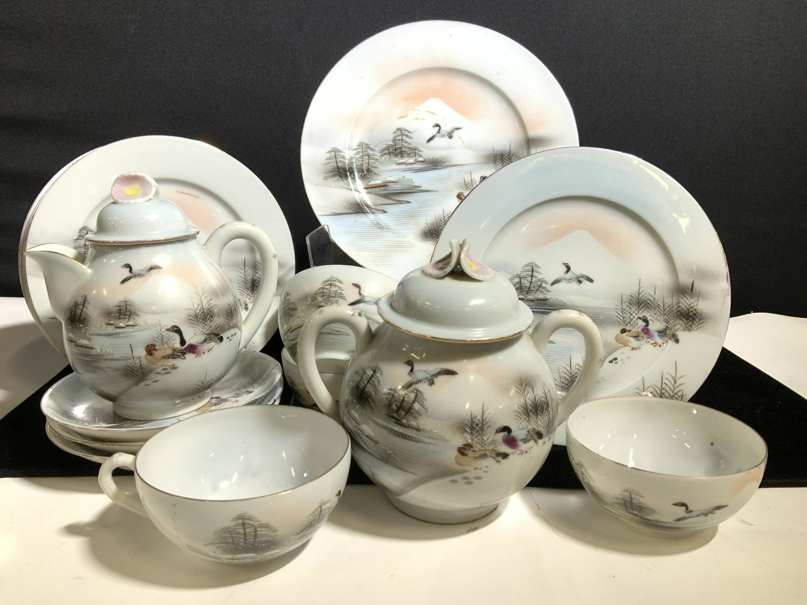 Fine Bone China Tea Set 18, Japan Hand Painted: Hand Painted tea set decorated with winter scene of ducks by a river and Mt. Fuji in background. Artist signed on each piece. 1 8.25 in Plate, 8 7.25 in plates, large lidded sugar bowl with lid , 5.5 