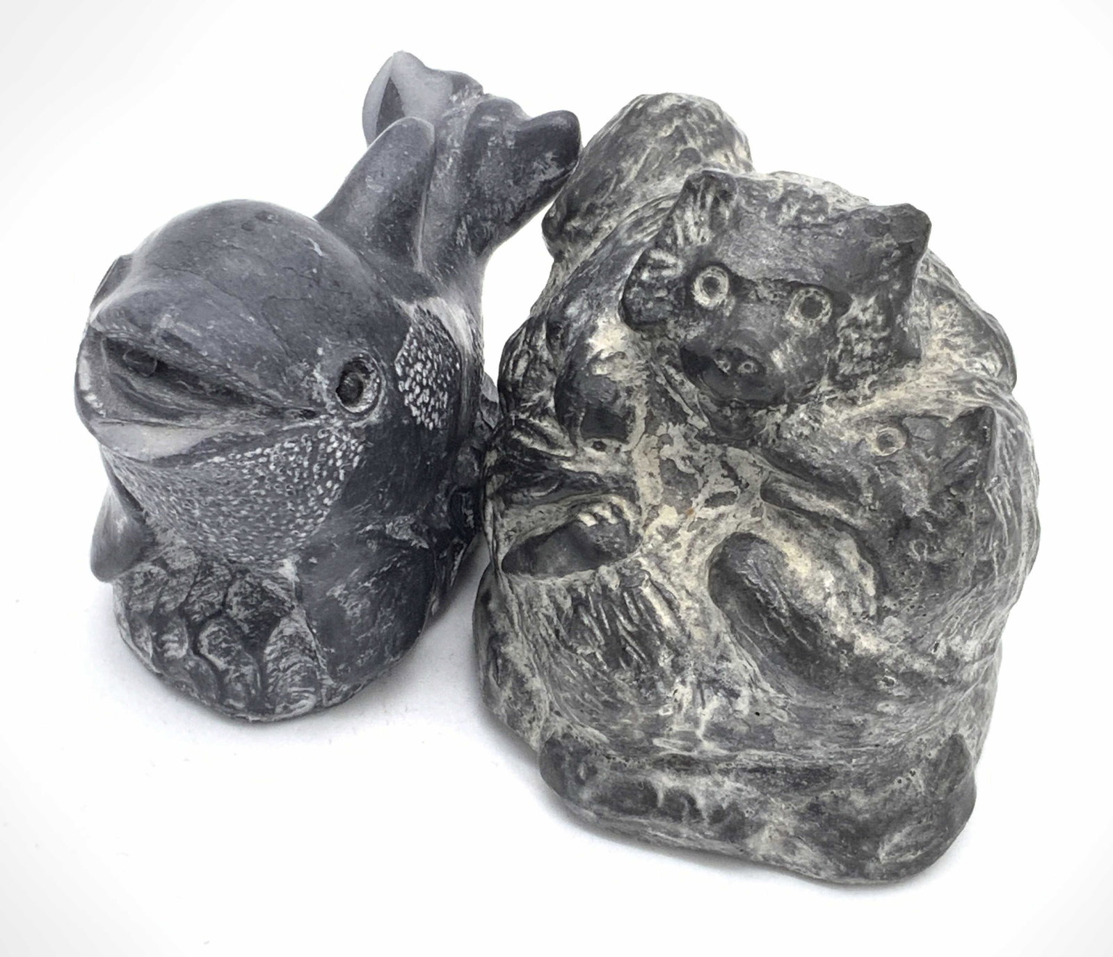 Lot 2 WOLF SCULPTURES Signed Soapstone Figurals: Two hand carved soapstone sculpture figurals. One piece depicts an orca whale. The underside reads THE WOLF SCULPTURES, ORIGINAL HANDMADE IN CANADA. The other figural depicts two wolves playing. Both 