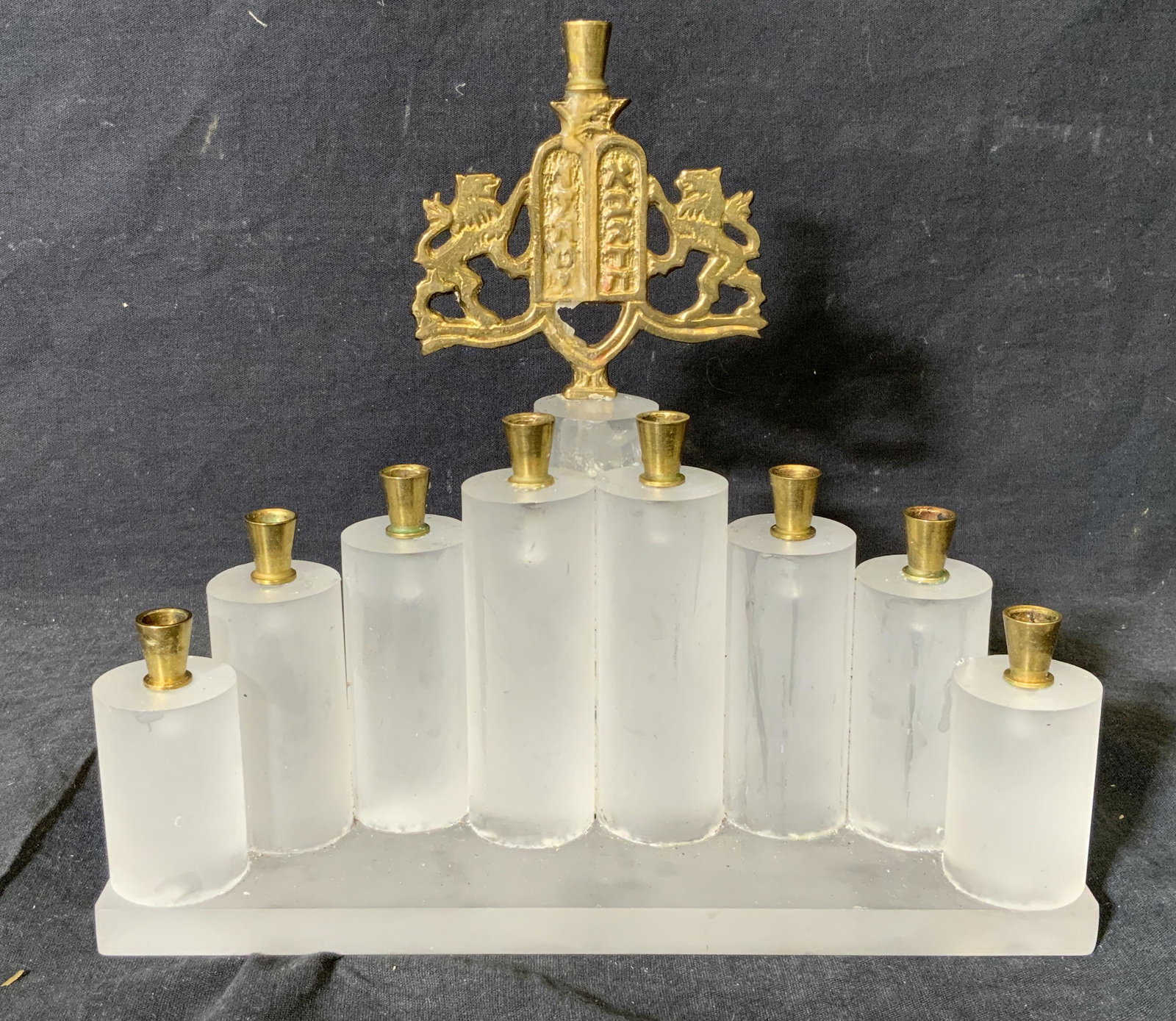 Resin Menorah with Metal Accents, Judaica: Resin Menorah with metal accents, possibly resin possibly composite, no apparent inscriptions or markings, piece is made of an opaque resin into 9 pillars and base, each pillar has a gold toned metal 