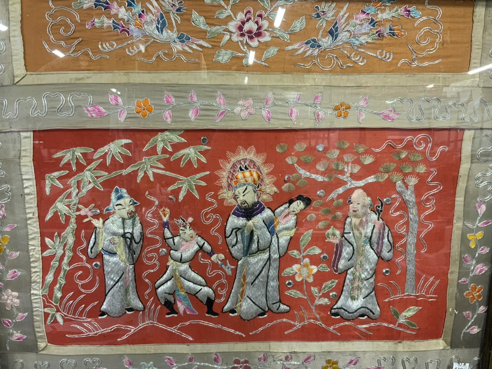 Framed Grande Chinese Embroidery Artwork: Framed grande Chinese Embroidery, no apparent inscriptions or markings, subject a pictorial embroidered scene of figures in a garden, border and secondary pictorial scene decorated with floral designs