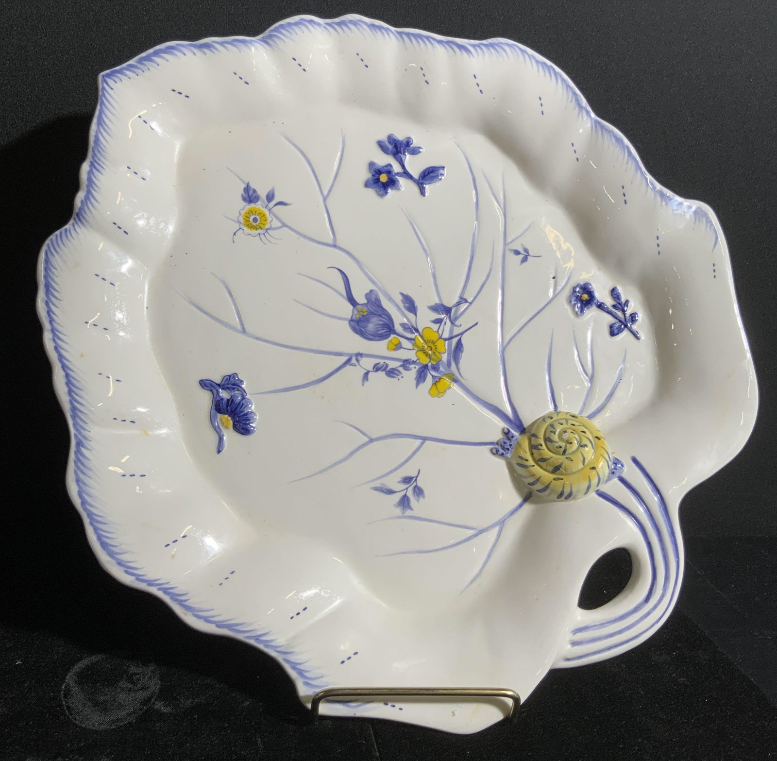 SPODE IMPERIAL GARDEN Signed Porcelain Platter: A white porcelain leaf form platter with hand painted designs. The piece features blue and yellow hued florals along the obverse. Raised and embossed porcelain florals and a snail are depicted on the 