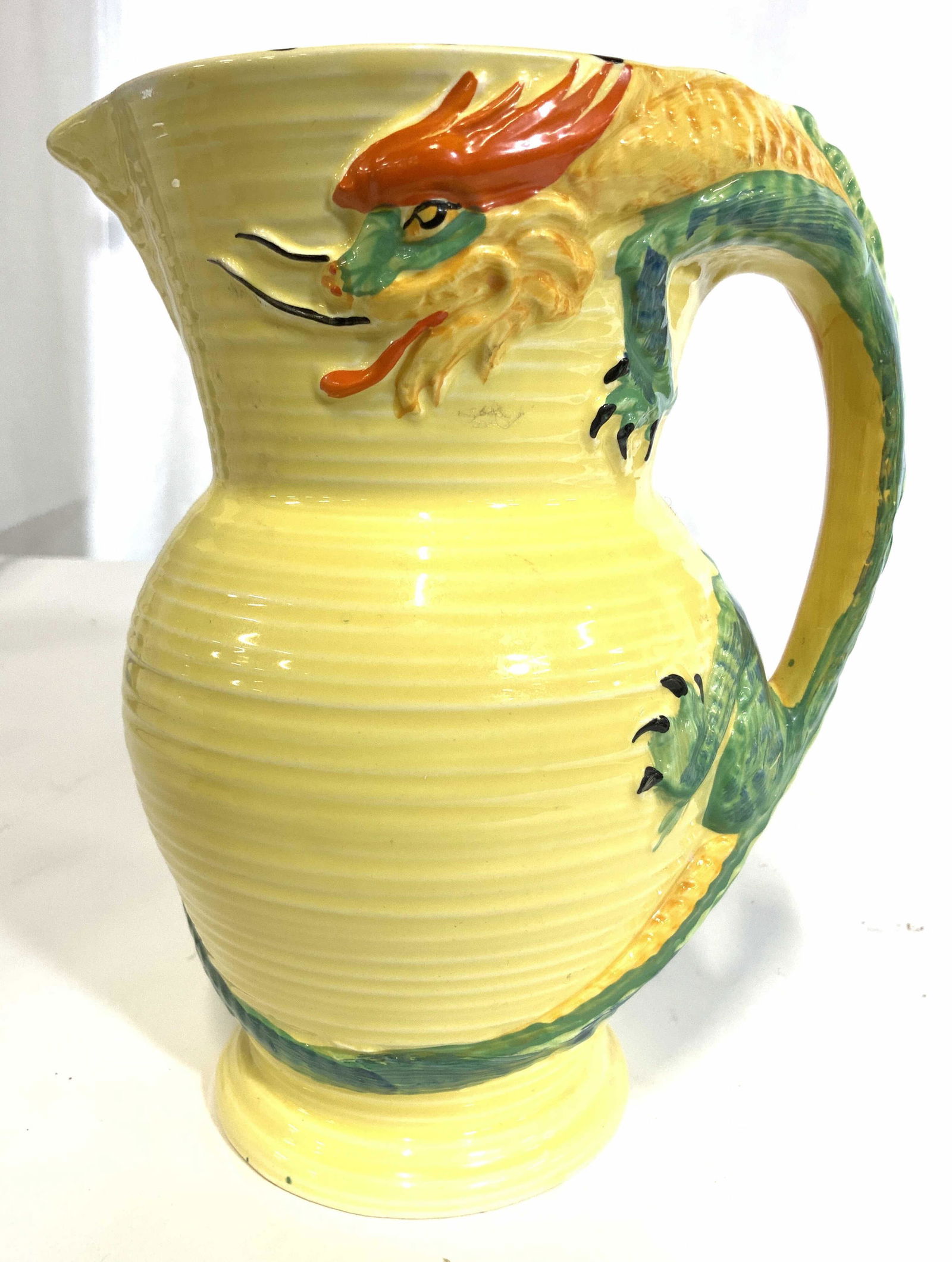 Vintage BURLEIGH WARE Hand Painted Dragon Jug: Underside of piece is marked BURLEIGH WARE BURSLEM ENGLAND. Jug has dragon form painted handle. Piece is hand painted with yellow base tone, & dragon detail. Piece measures approx 8 inches tall 6.5 in