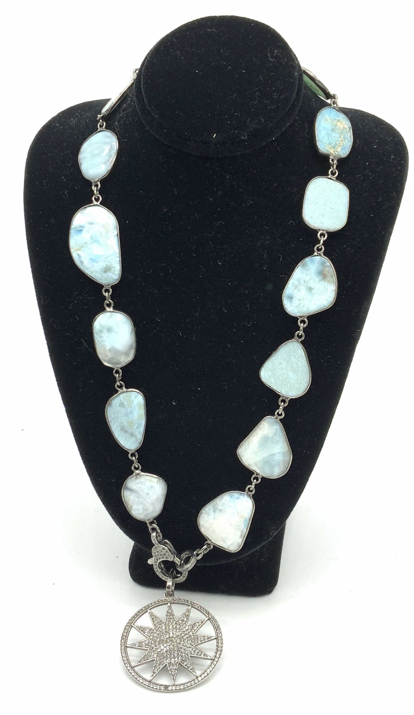 Larimar & Sunburst Diamond Encrusted Necklace: Pendant necklace with sunburst Diamond encrusted pendant, tests positive for Diamond on gem tester, blue stone larimar, only found in Dominican Republic. Pendant 1 1/4 in diameter. 1 missing diamond o