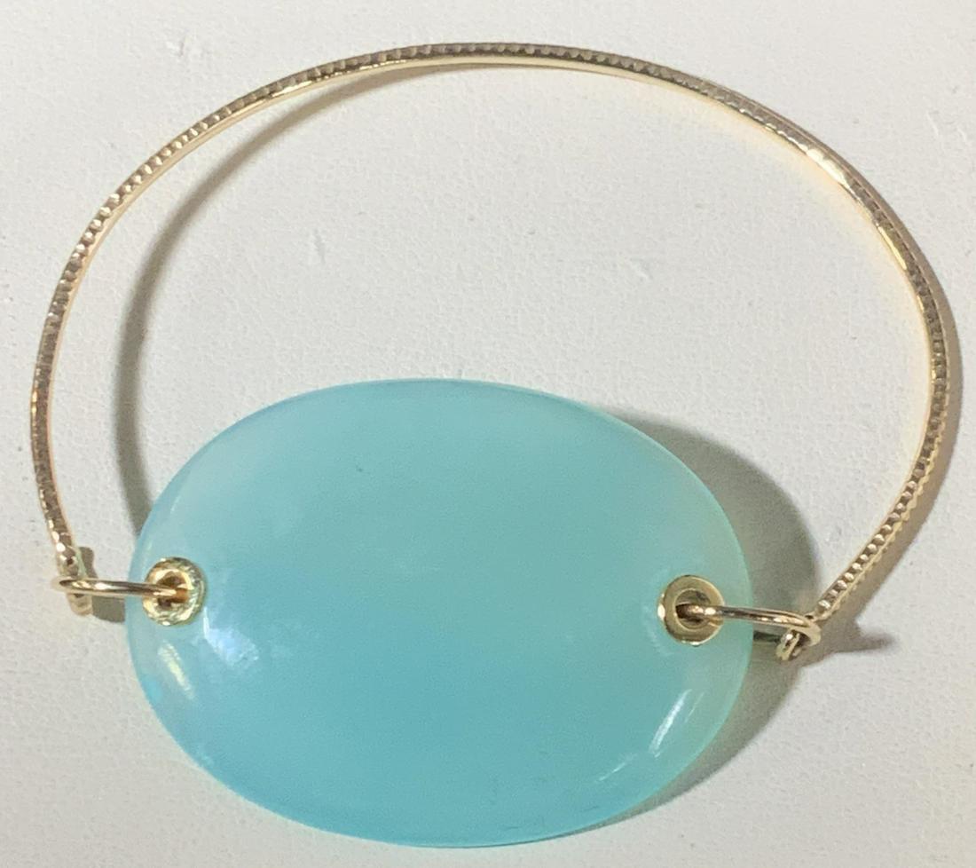 Arts and Crafts Gold Bracelet with Glass medallion: Hand crafted bracelet, Tests positive for 14 k gold, no marks on metal noted aqua glass Cabochon centerpiece, oval 1.5 in. Wrist 2+ in. wide. 2.5 dwt for gold only. Arts and crafts jewelry, cocktail w
