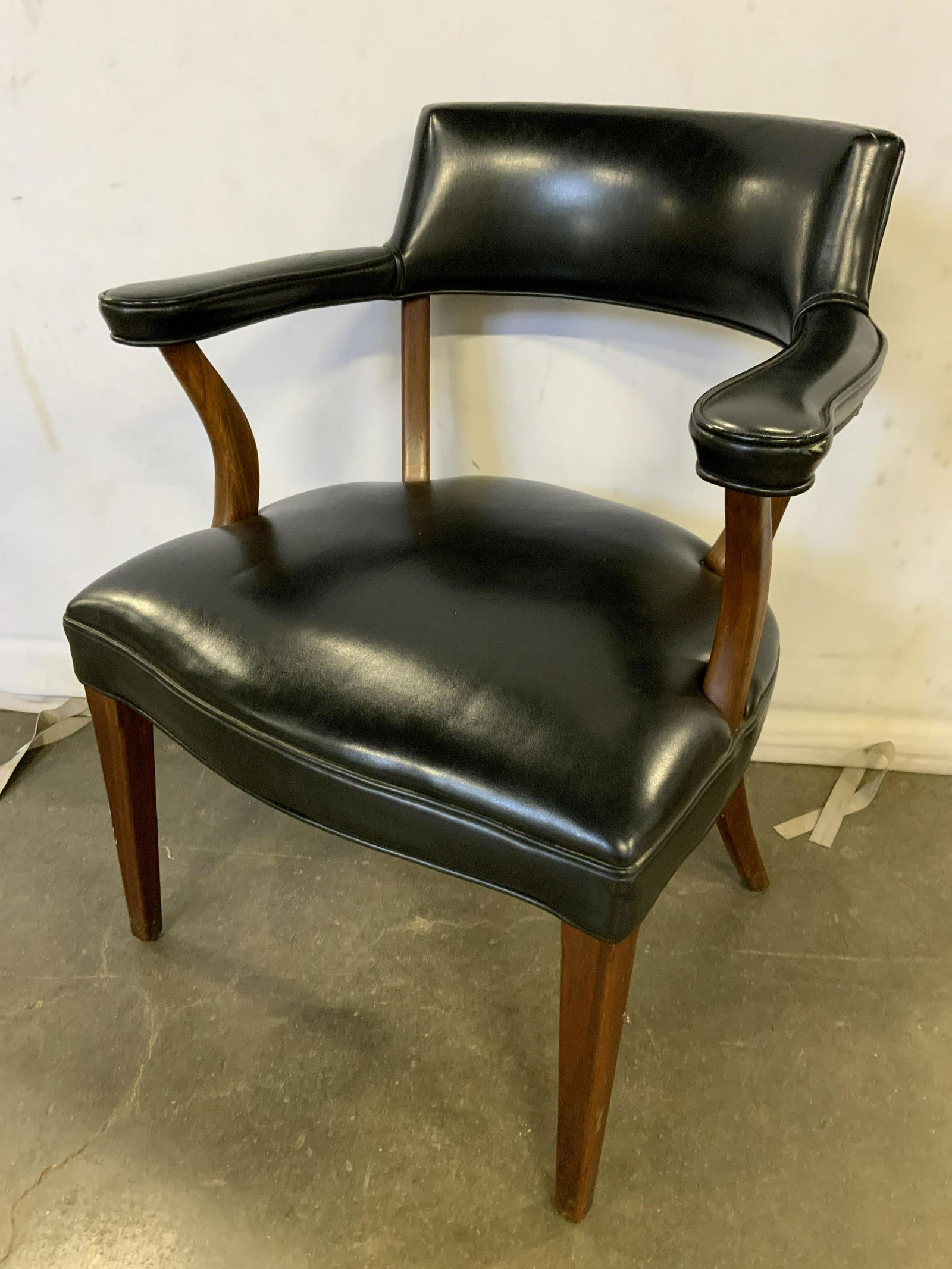 Leather Club Chair: Leather club chair, possibly vintage. Leather secured to a wood frame, leather is single welted. Wear is consistent with age and use, tearing present on underside lining. Measures approx 31 inches H,