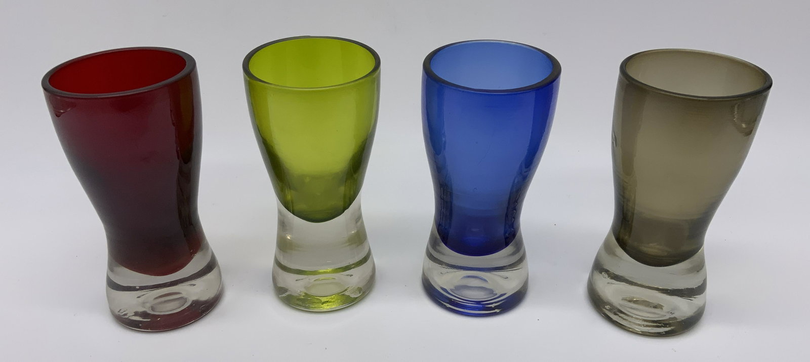 Group Lot 4 Art Glass Shot Glasses: Group Lot 4 Art Glass Shot Glasses, no apparent inscriptions or markings, subject 4 colored art glass shot glasses, each glass has a clear bottom with a different colored top consisting of either blue