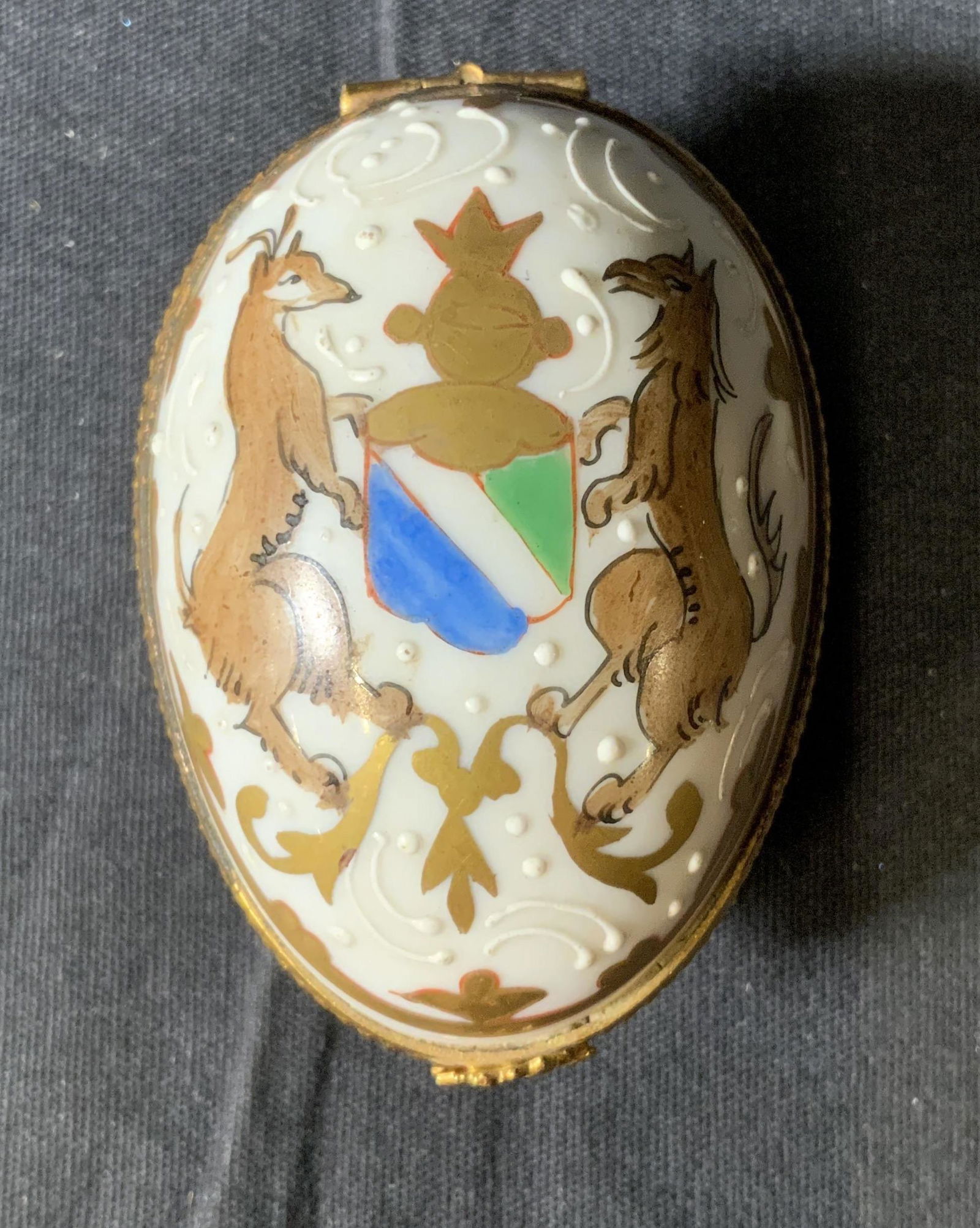 LIMOGES FRANCE Porcelain Pill Box: LIMOGES FRANCE Porcelain Pill Box, inscription partially illegible, reads ‘Decor main Parls style Limoges France’, measures 1 1/2 inches tall x 2 1/2 inches at widest point, surface wear to piece,