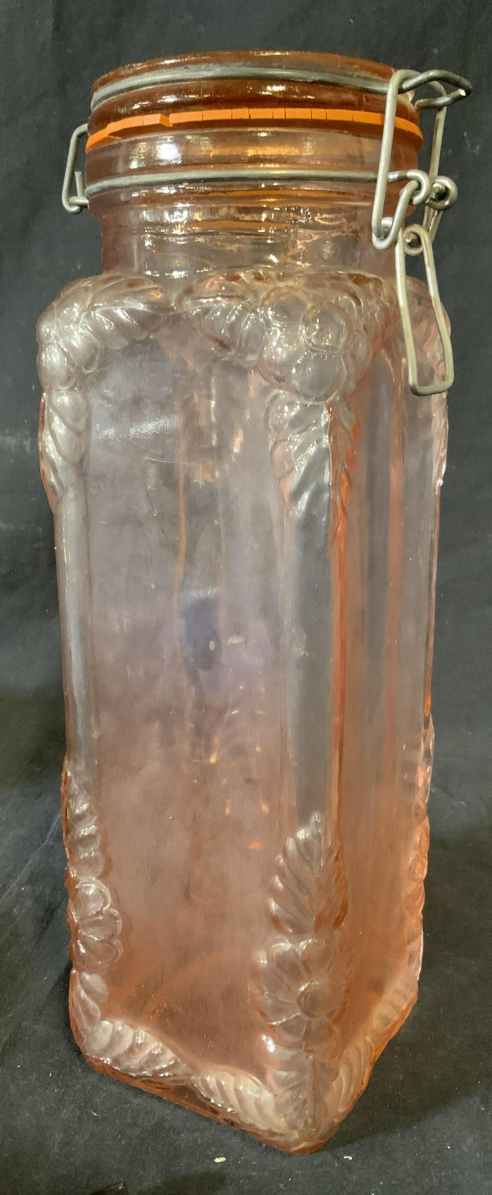 Vintage Depression Glass Style Container, Italy: Vintage depression glass style vessel. Decorated with floral and leaf like detail, in relief. Lid can be secured with a metal clasp. Underside reads as MADE IN ITALY. Wear is consistent with age and u
