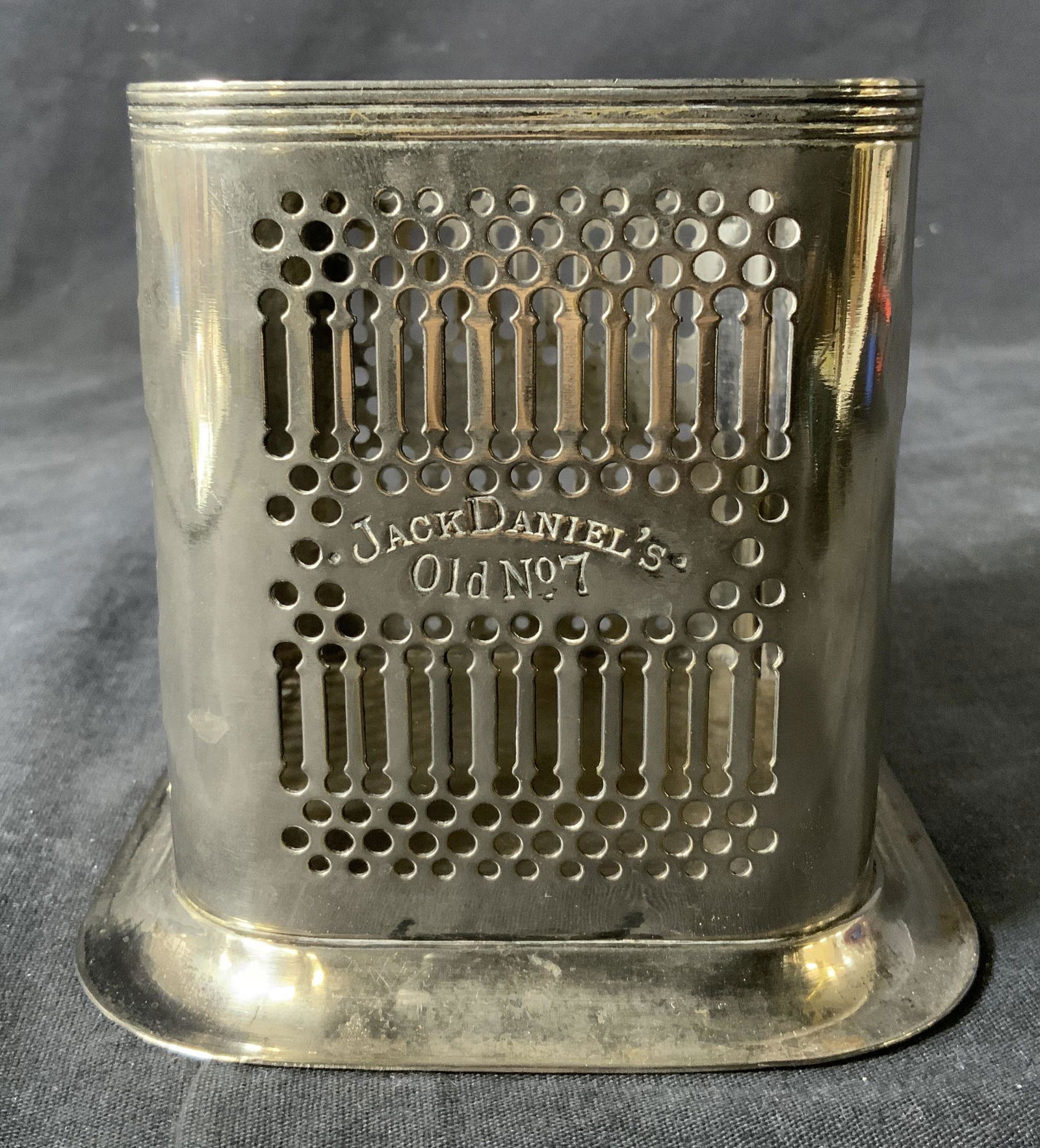 JACK DANIELS Silver Plated Bottle Holder: JACK DANIELS Silver Plated Bottle Holder, inscription reads ‘Jack Daniels Old No 7’ and ‘Best Silverplate JD Made in England’, measures 4 1/8 inches tall x 4 1/2 inches wide at base, surface w