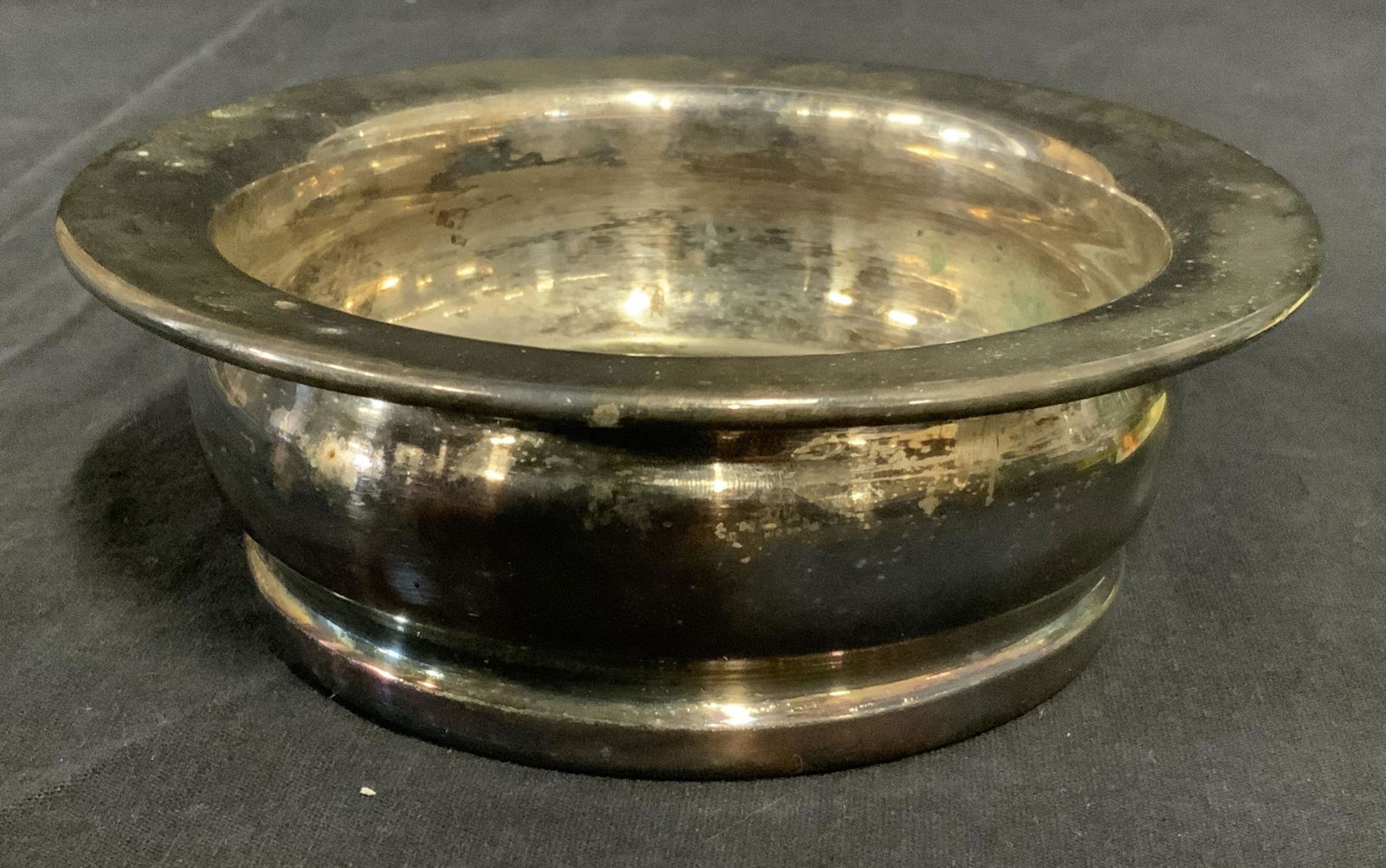 FB ROGERS SILVER CO Wine Coaster: Silver plated wine coaster, base is wood, underside is lined with fabric. Underside reads as FB ROGERS SILVER CO. Measures approx 2 inches H and 6 inches in diameter. Wear is consistent with age and u