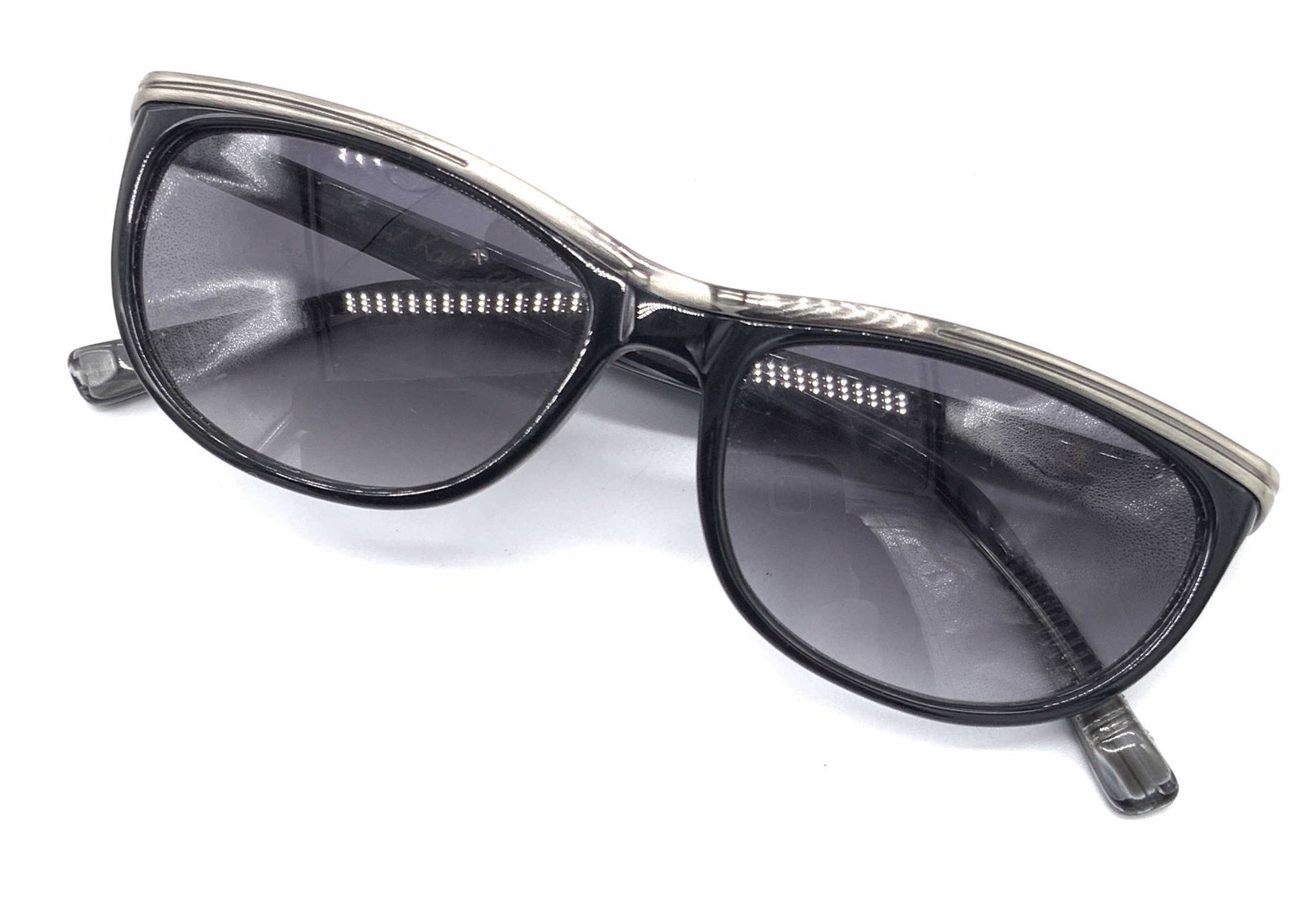 VINCENT KAES Signed ‘Old School’ Sunglasses: A pair of black and silver toned sunglasses. Interior is signed VINCENT KAES, OLD SCHOOL. Tips are ribbed. Approx. 1.5L x 5.25W in. Piece possesses some wear consistent with use. Vincent kaes sunglass