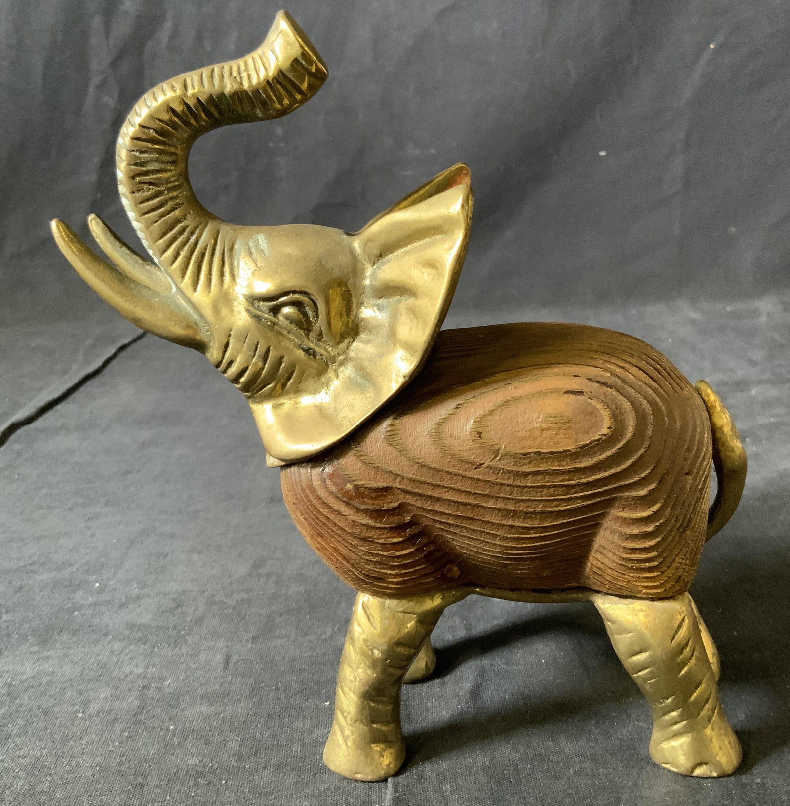 Metal and Wooden Elephant Sculpture: Metal and Wooden Elephant Sculpture, no apparent inscriptions or marks, subject an elephant with a raised trunk, measures 7 inches tall x 6 1/2 inches at widest point, surface wear to piece, oxidation