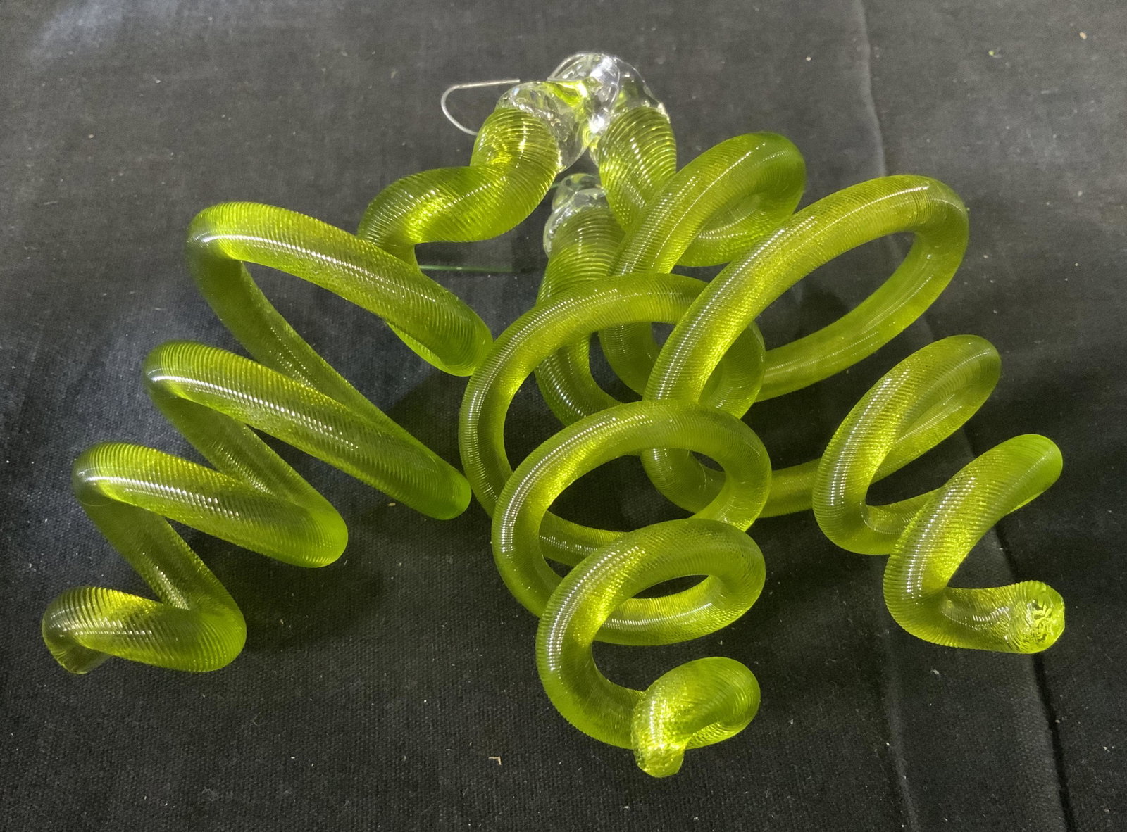 3 Susan Knecht Glass Christmas Ornaments: 3 Susan Knecht Glass Christmas ornaments, all three are packaged in a white shipping box with a label to the interior that reads Before & Again, each is bright green glass spiral, box measures 9 inche