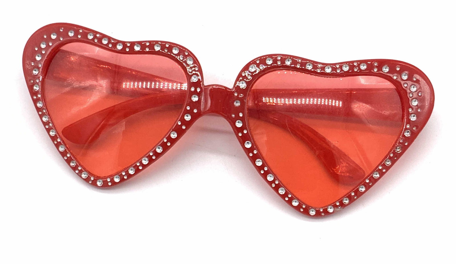 Signed GREENBRIE Red Heart Shaped Sunglasses: A pair of retro red style heart shaped sunglasses. The glasses are decorated with silver hued accents along the rims. Interior reads GREENBRIER INTERNATIONAL INC. Approx. 2.5L x 6W in. Piece possesses